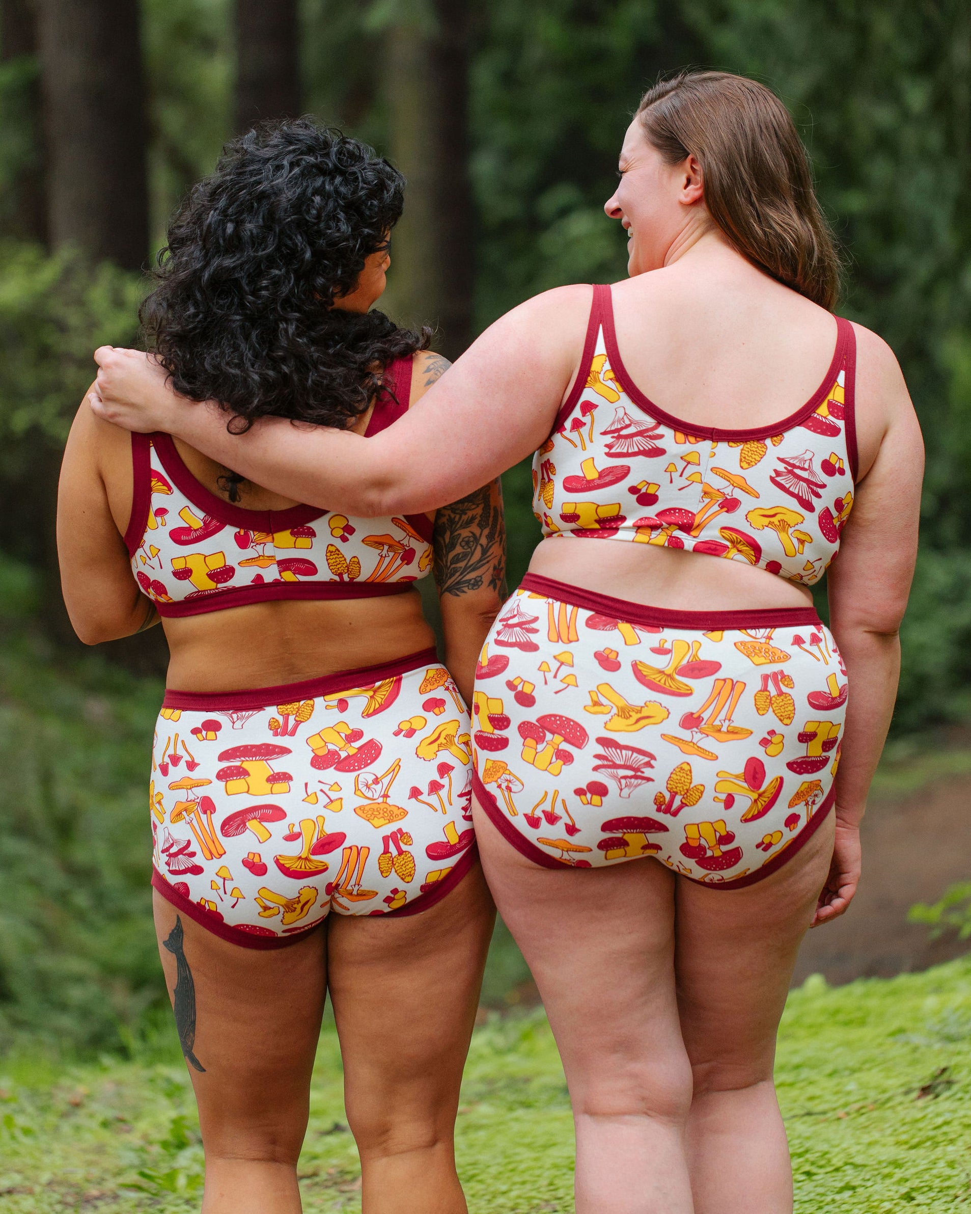 Two models wearing Thunderpants Sky Rise style underwear and Bralette in Whadda Fungi print - red, yellow, and orange mushroom print.