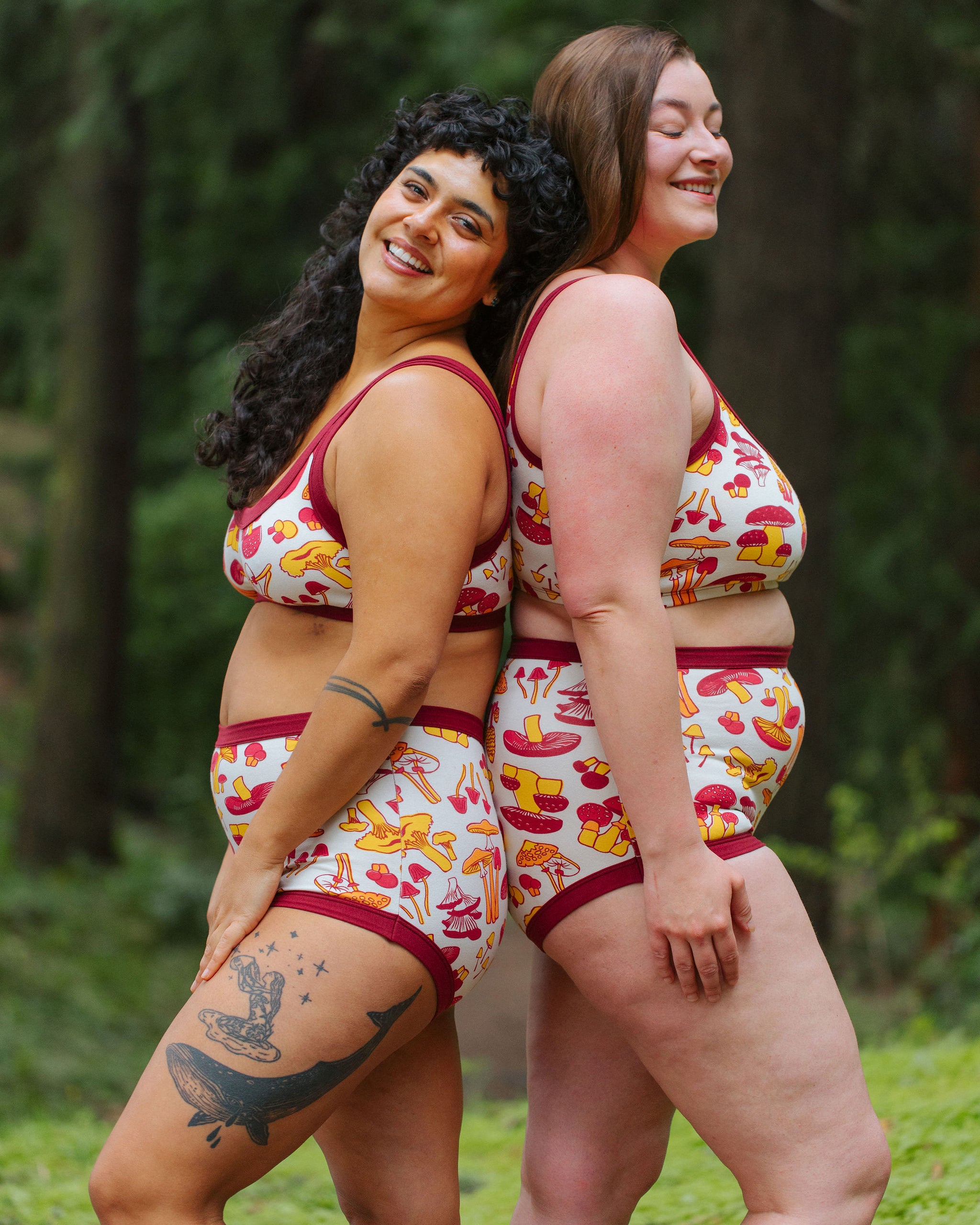 Two models wearing Thunderpants Sky Rise style underwear and Bralette in Whadda Fungi print - red, yellow, and orange mushroom print.