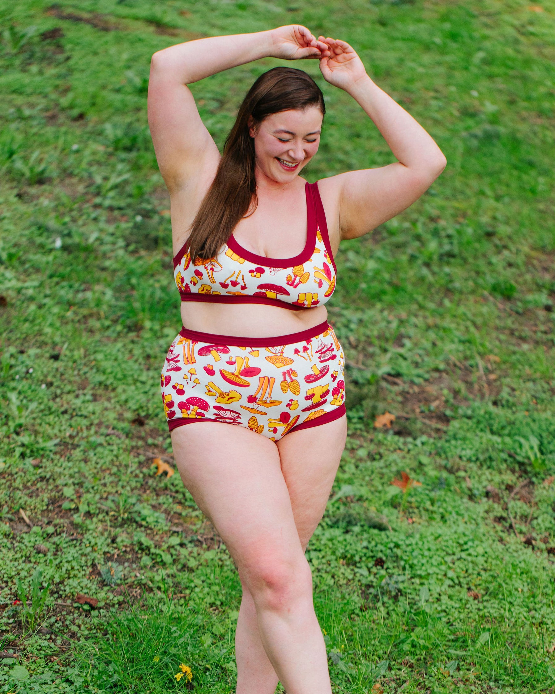 Model wearing Thunderpants Sky Rise style underwear and Bralette in Whadda Fungi print - red, yellow, and orange mushroom print.