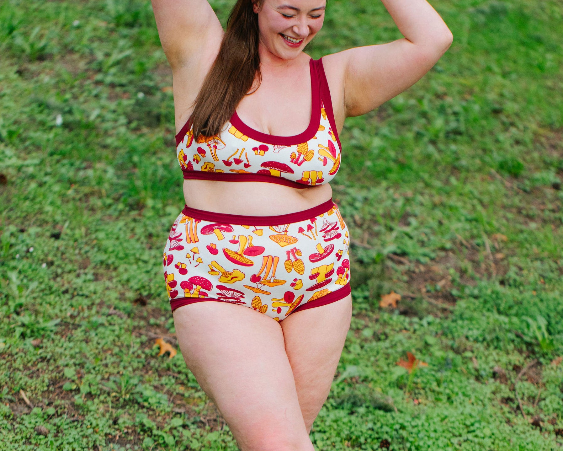 Model wearing Thunderpants Sky Rise style underwear and Bralette in Whadda Fungi print - red, yellow, and orange mushroom print.