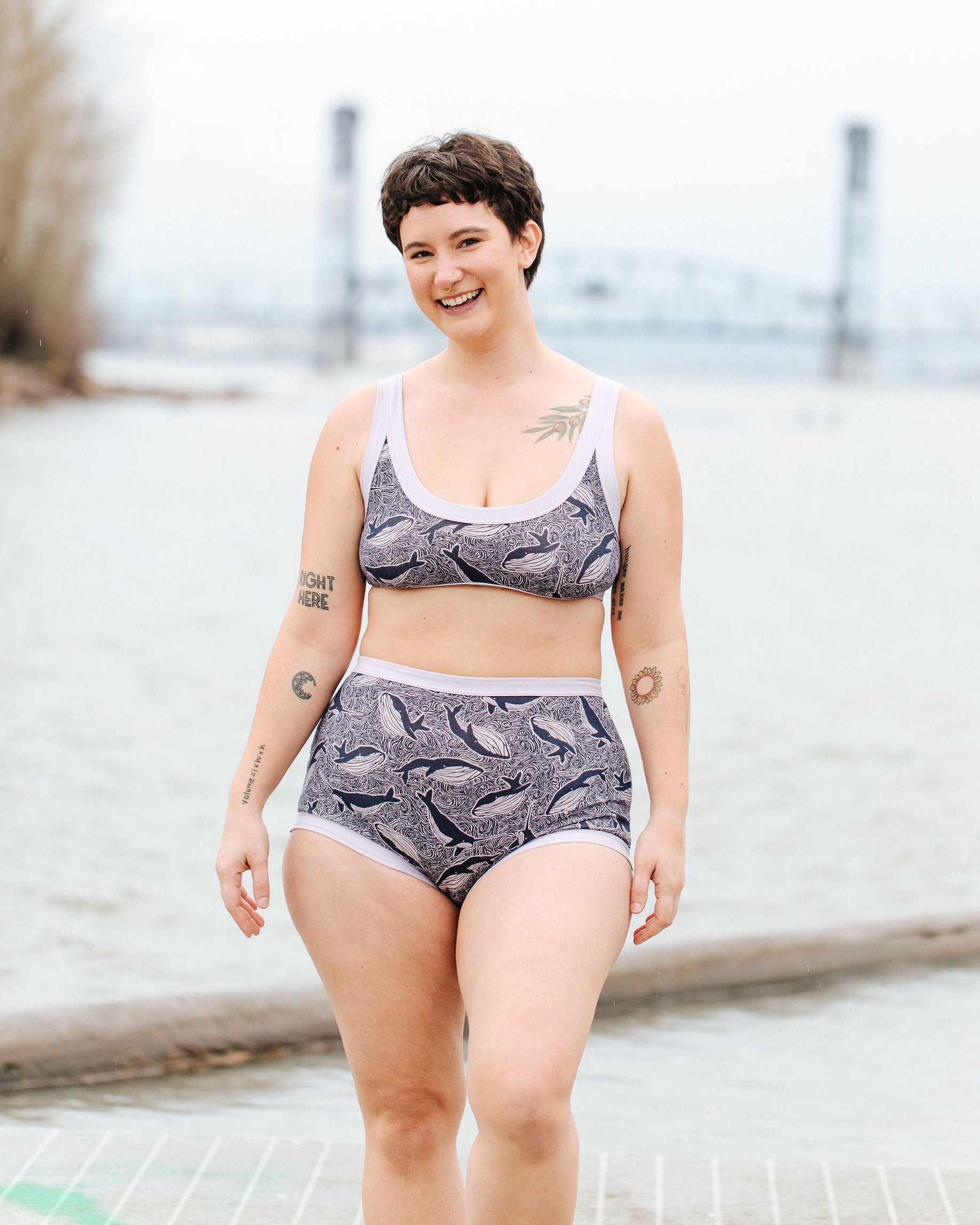 Model wearing Thunderpants Sky Rise style underwear and Bralette in Whale, Whale, Whale print - indigo whales on lavender.