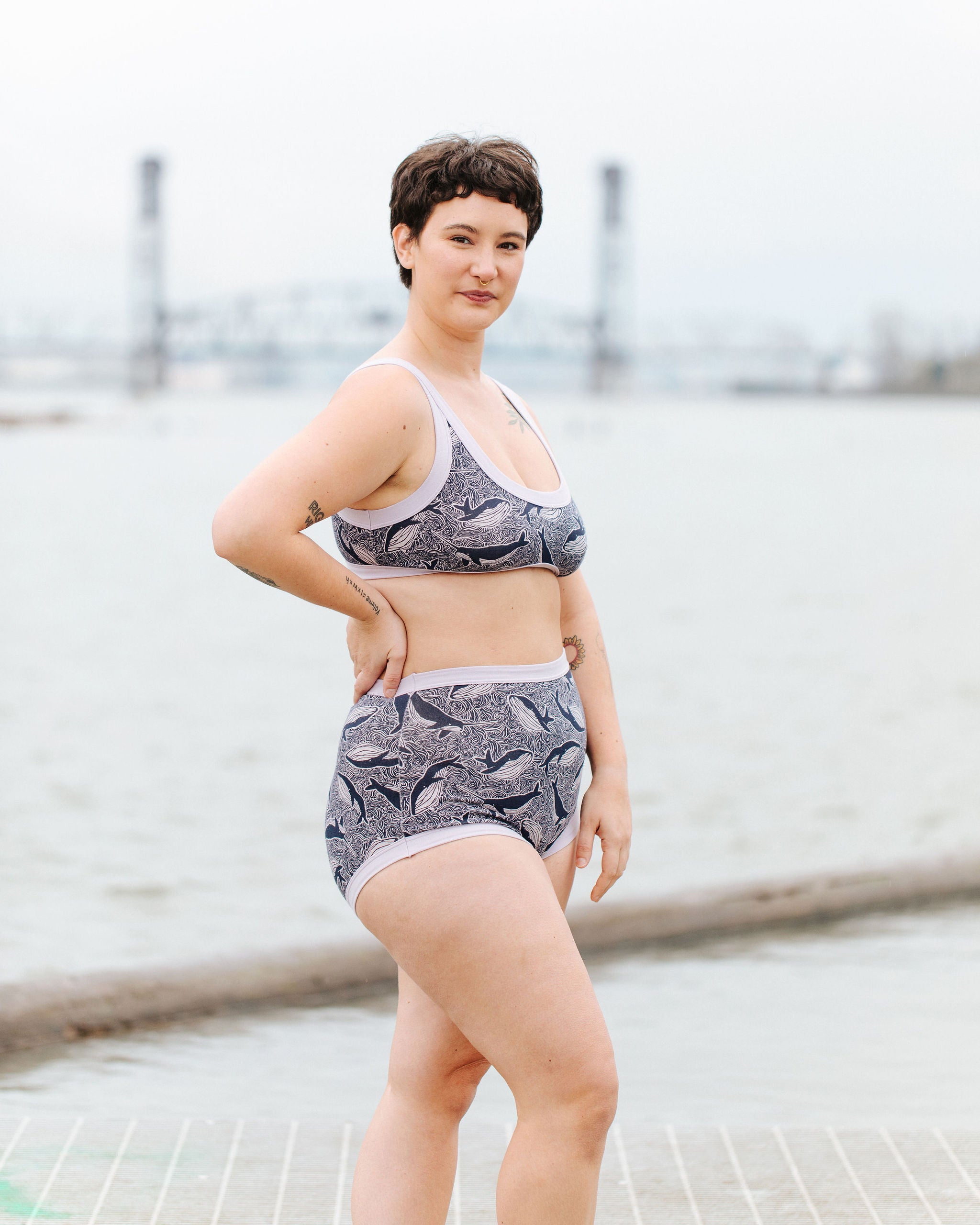 Model wearing Thunderpants Sky Rise style underwear and Bralette in Whale, Whale, Whale print - indigo whales on lavender.