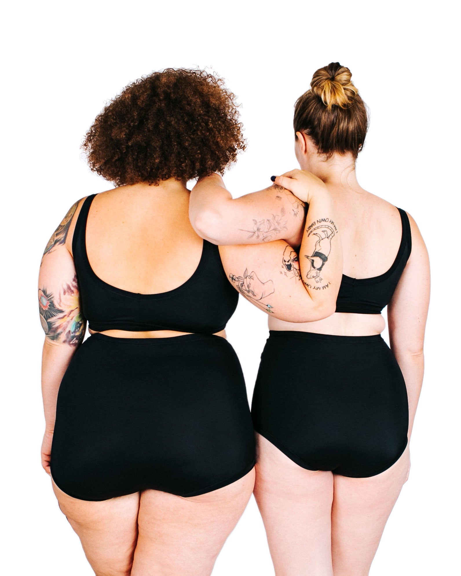 Fit photo from the back of Thunderpants recycled nylon Swimwear Sky Rise style bottoms and Swimwear Top in Plain Black on two models standing together.