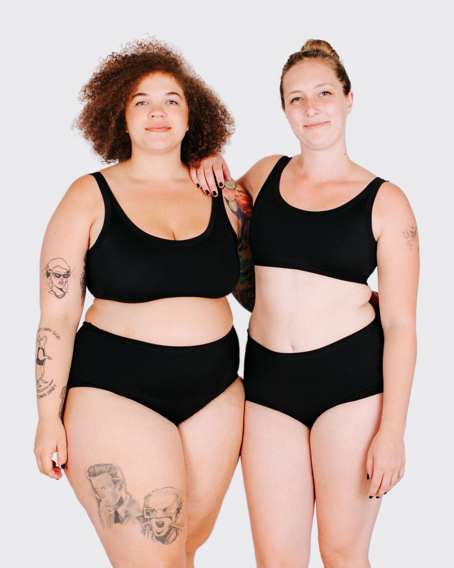 Fit photo from the front of Thunderpants recycled nylon Swimwear Top and Original style Swimwear bottoms in Plain Black on two models standing together.
