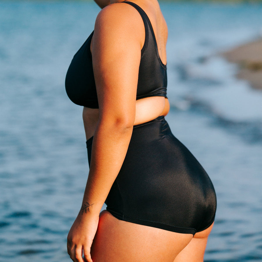 Model wearing Swimwear Sky Rise style bottoms in Plain Black color.