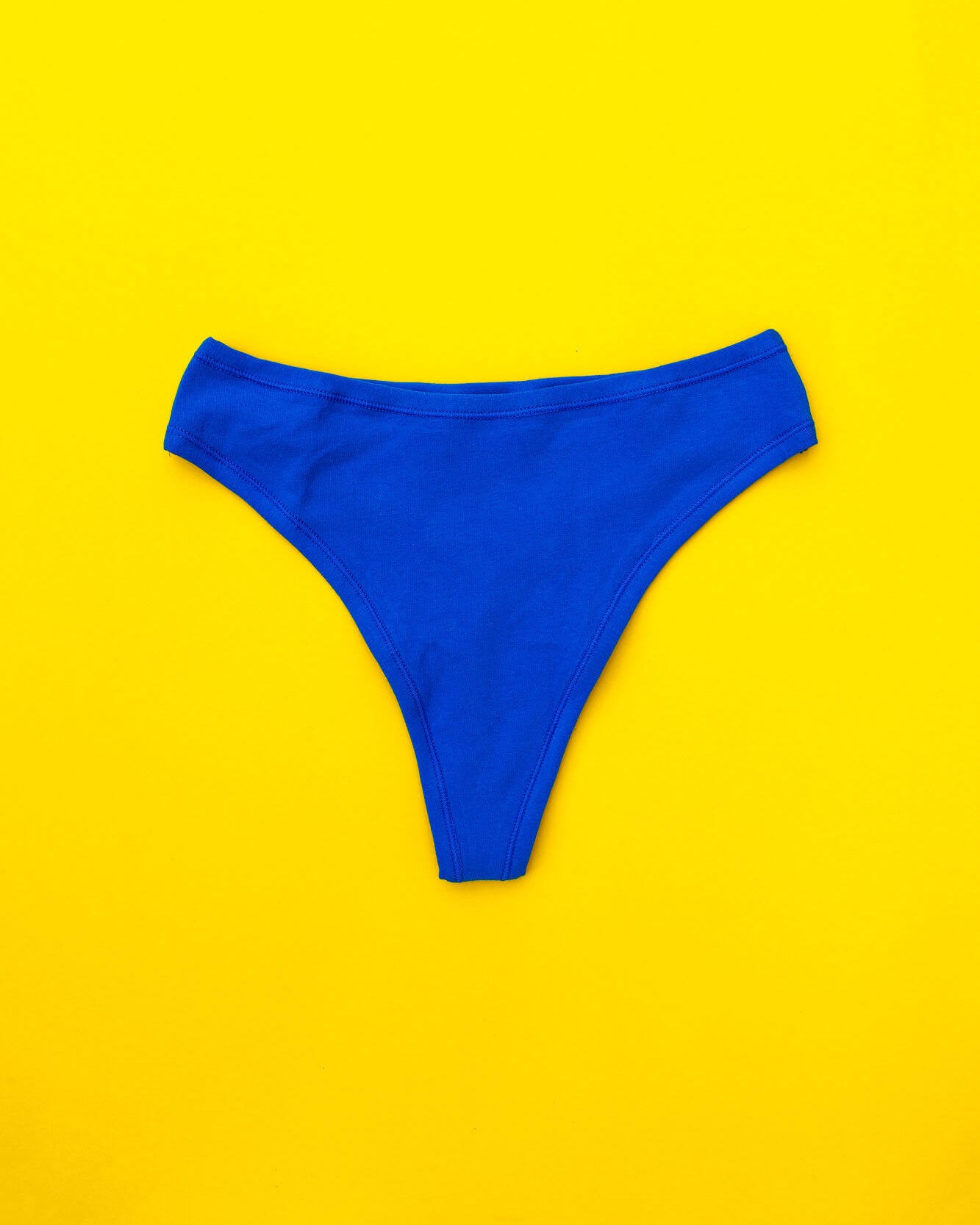 Flat lay of Thunderpants Organic Cotton Thong style underwear in Blueberry Blue.