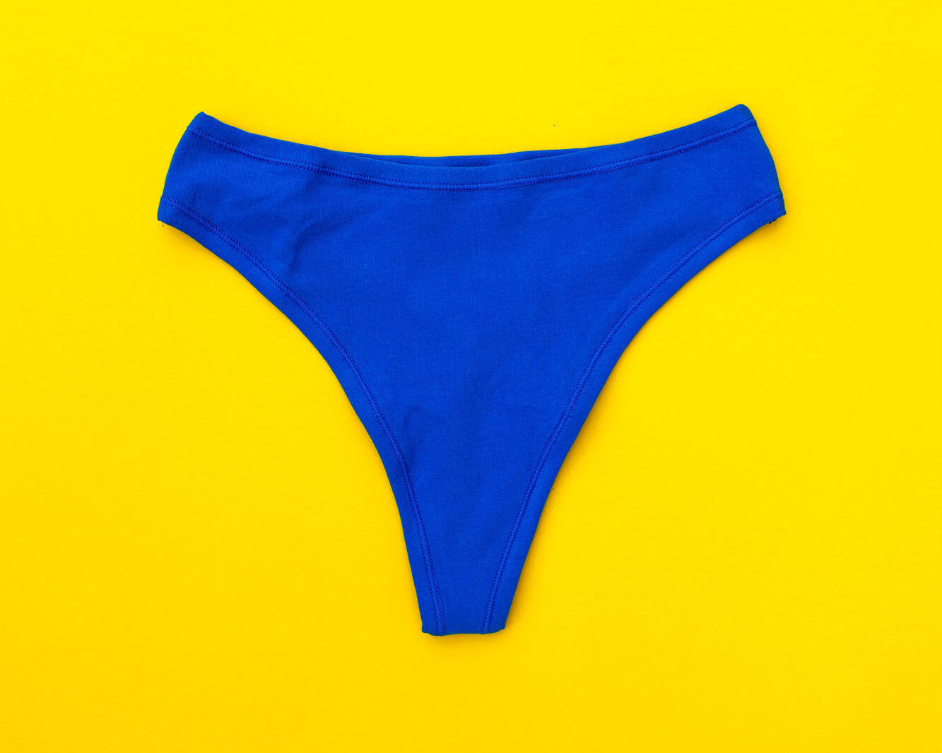 Flat lay of Thunderpants Organic Cotton Thong style underwear in Blueberry Blue.