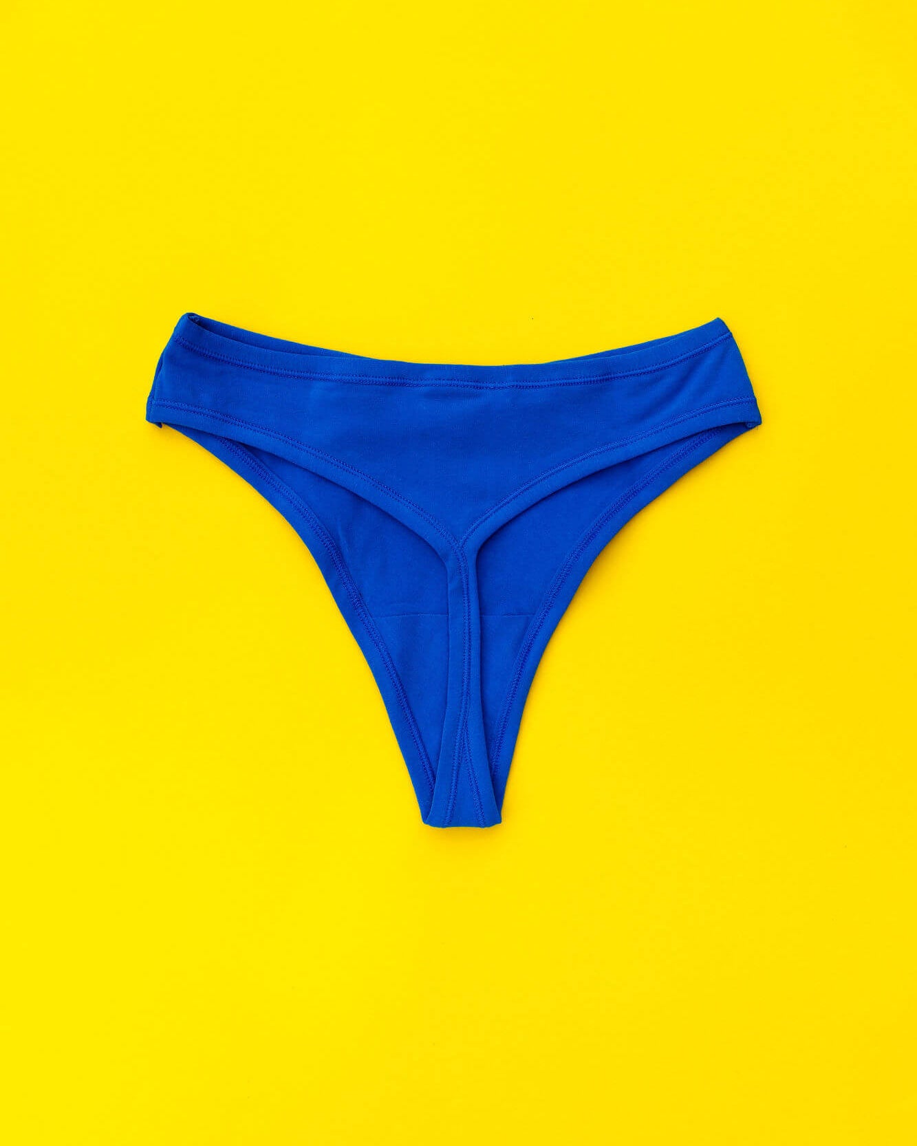 Flat lay of Thunderpants Organic Cotton Thong style underwear in Blueberry Blue.