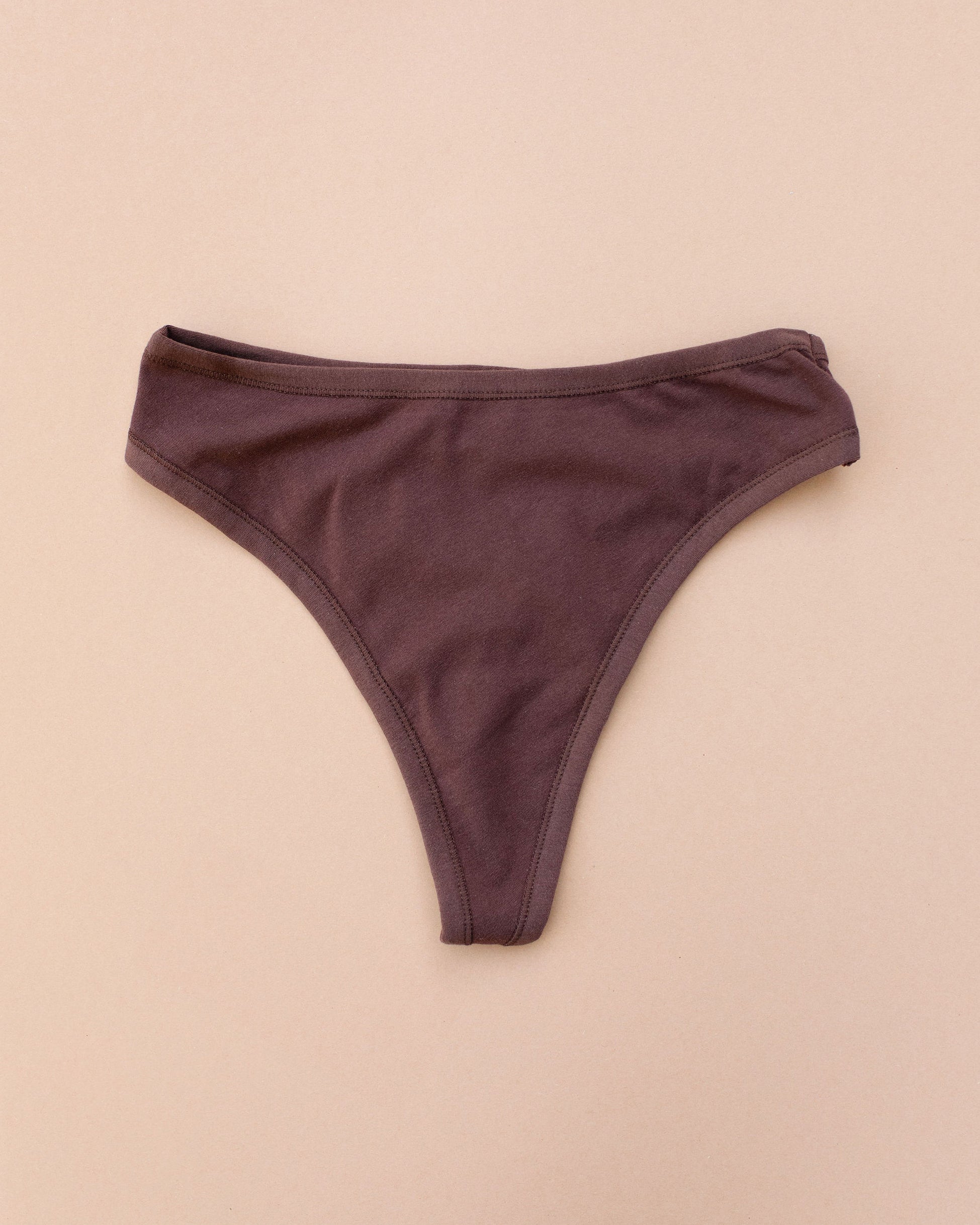 Flay lay of Thunderpants Thong style underwear in Chestnut - a dark brown.