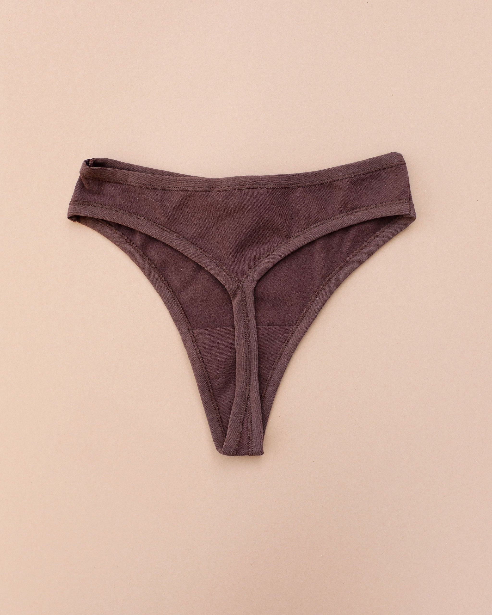 Flay lay of Thunderpants Thong style underwear in Chestnut - a dark brown.