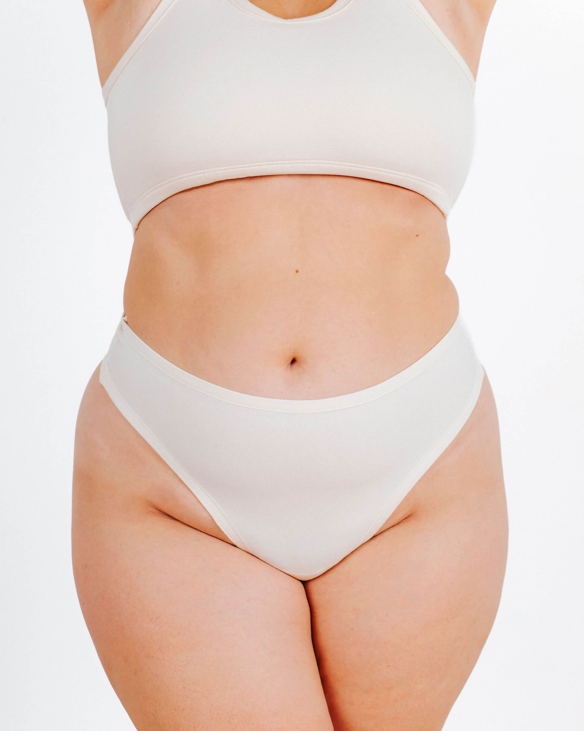 Front fit photo of a model in Thunderpants organic cotton Thong style underwear in Plain Vanilla.