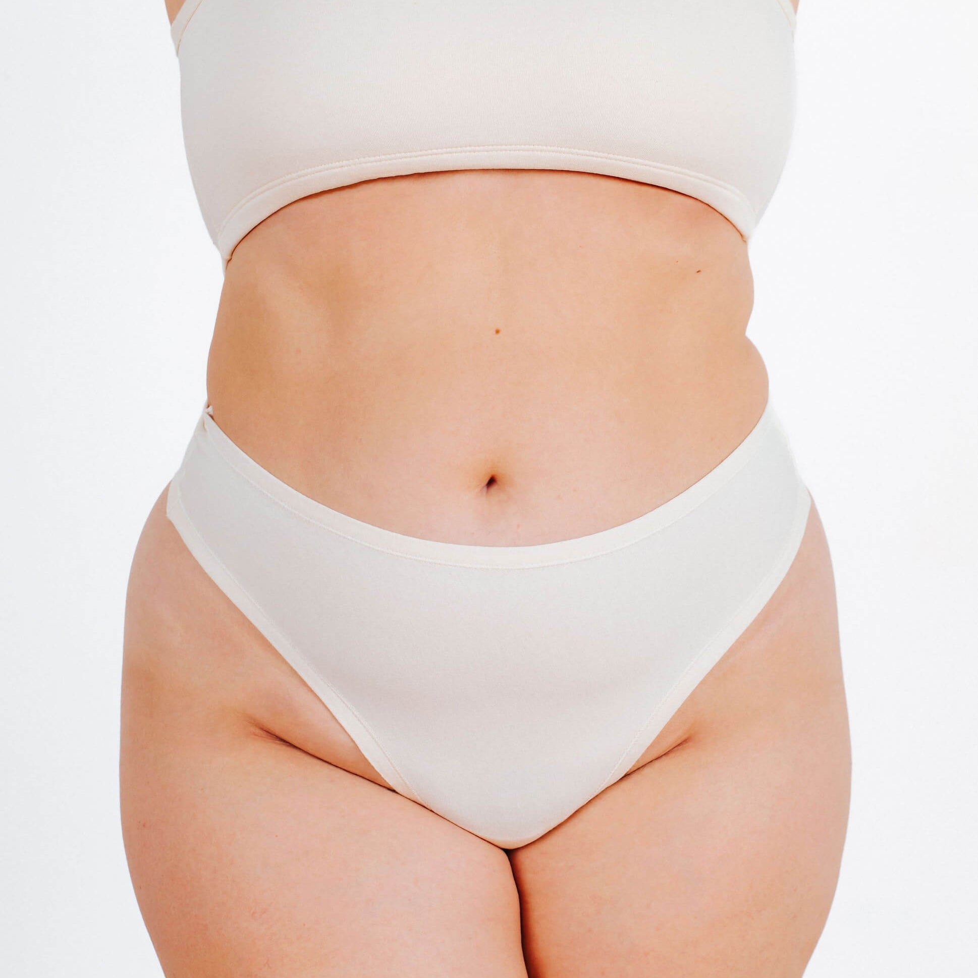 Front fit photo of a model in Thunderpants organic cotton Thong style underwear in Plain Vanilla.