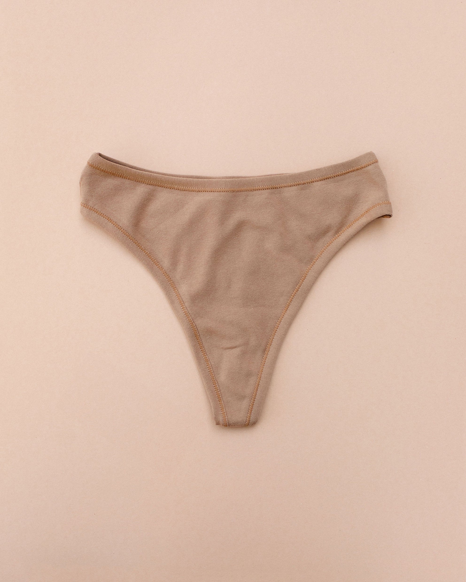 Flat lay of Thunderpants Thong style underwear in Hazelnut - a mid-brown color.