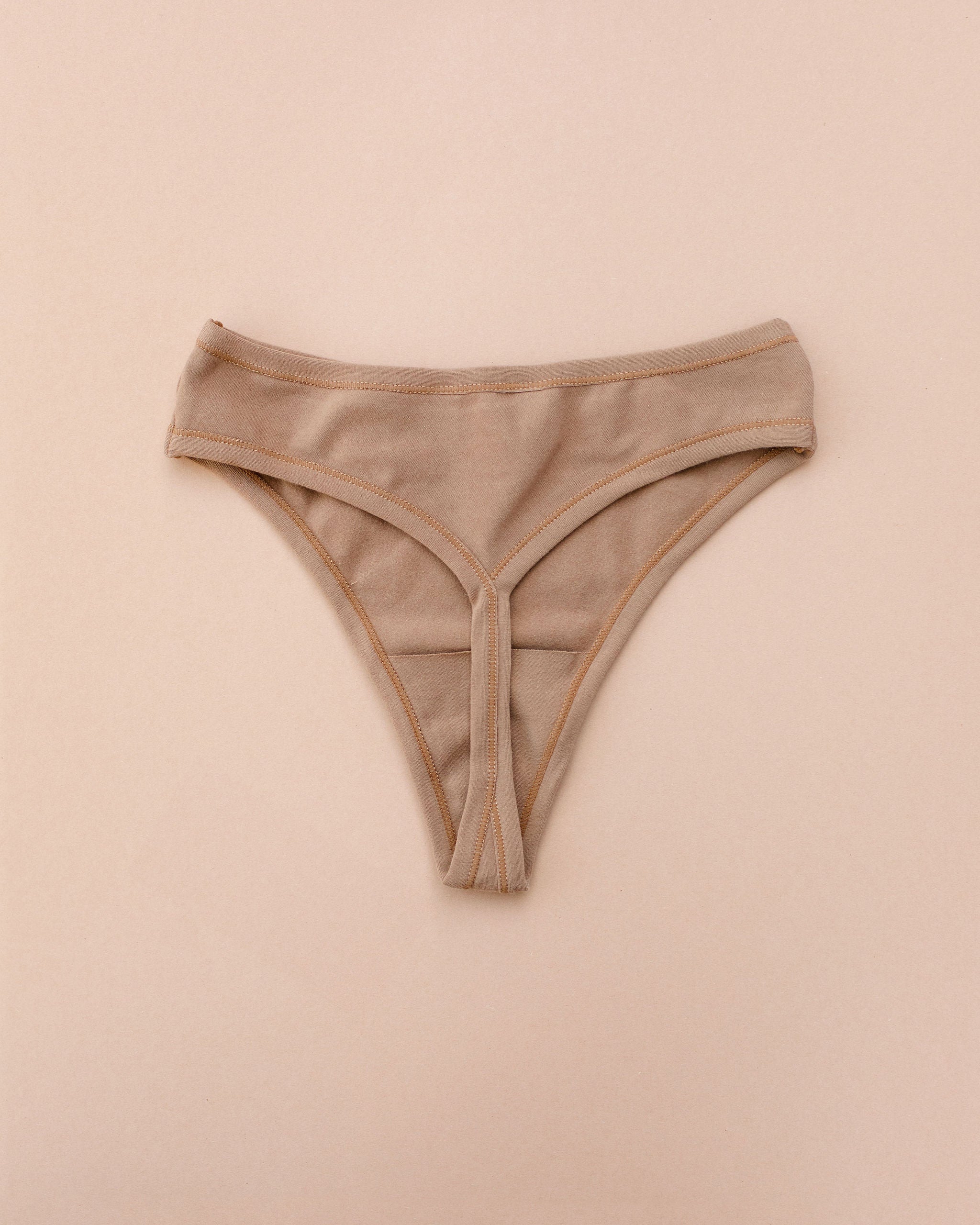 Flat lay of Thunderpants Thong style underwear in Hazelnut - a mid-brown color.
