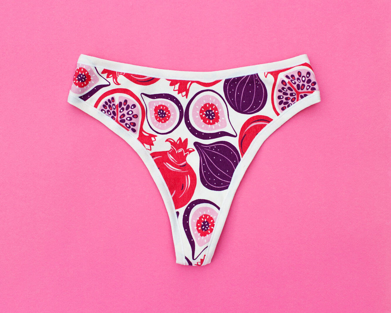 Flat lay of Thunderpants Thunder Thong in Two Fruits print - Pomegranates and Figs.