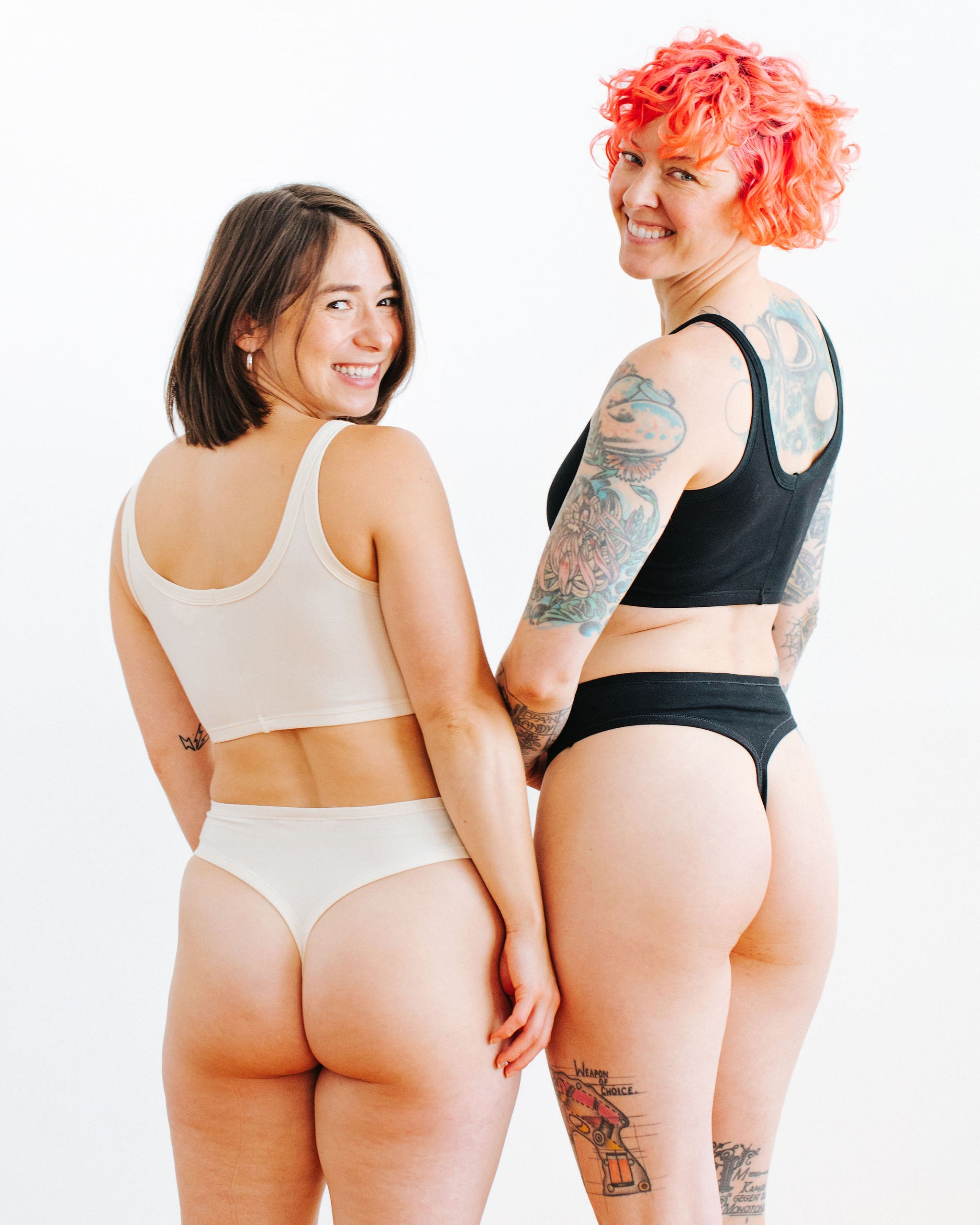 Two models wearing sets in Thunderpants Thong style underwear and Long Line Bra in Plain Vanilla and Plain Black.