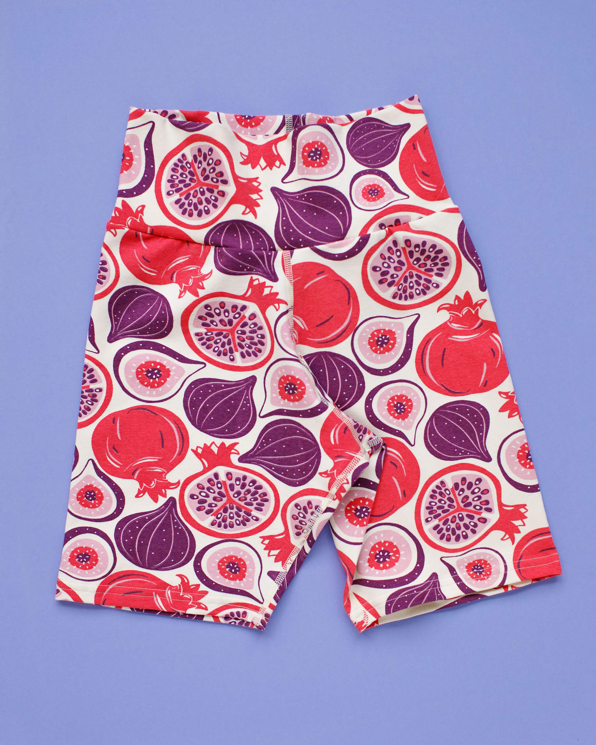 Flat lay of Thunderpants Bike Shorts in Two Fruits print - figs and pomegranates.