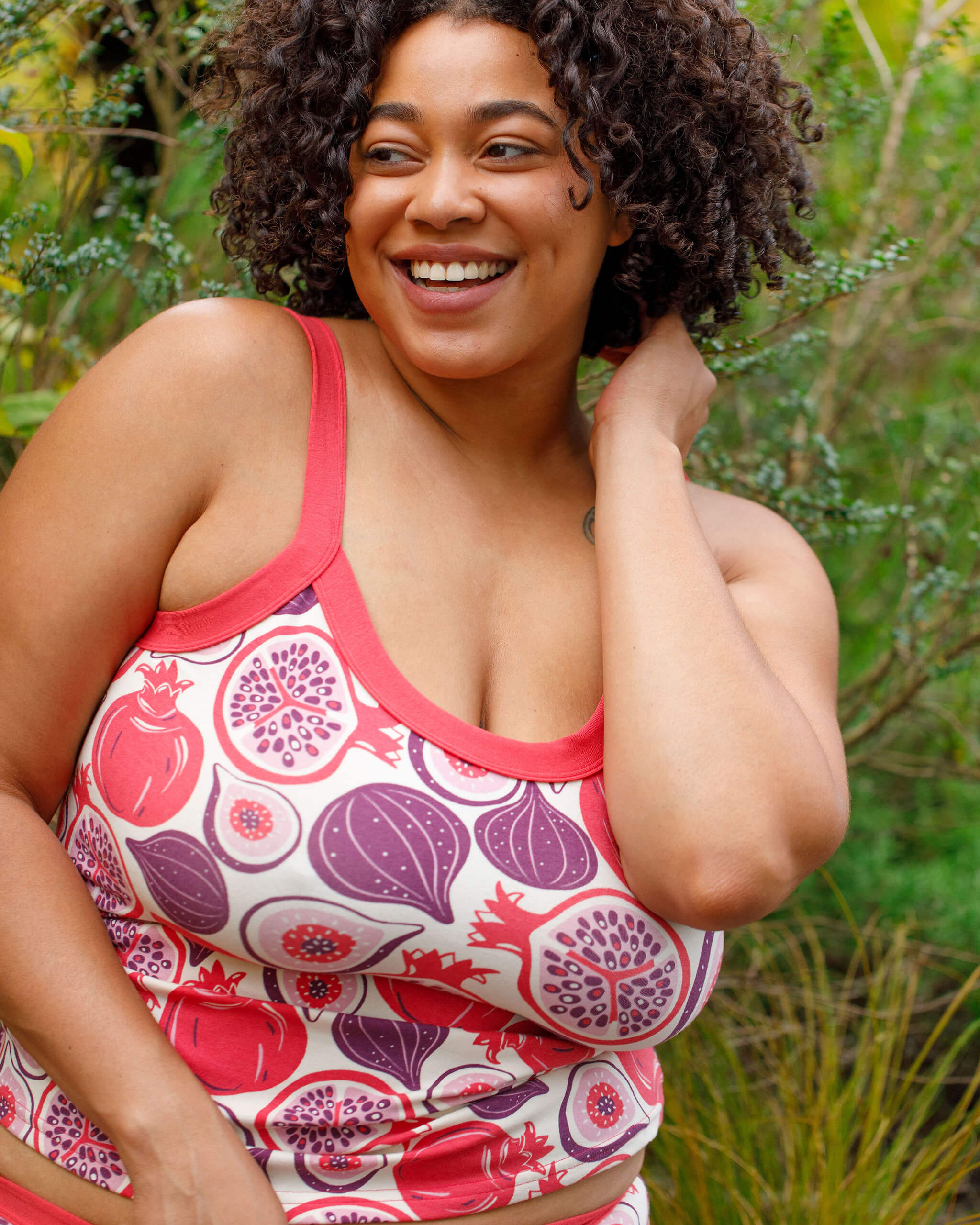 Close up of model wearing Thunderpants Camisole in Two Fruits - pomegranates and figs.