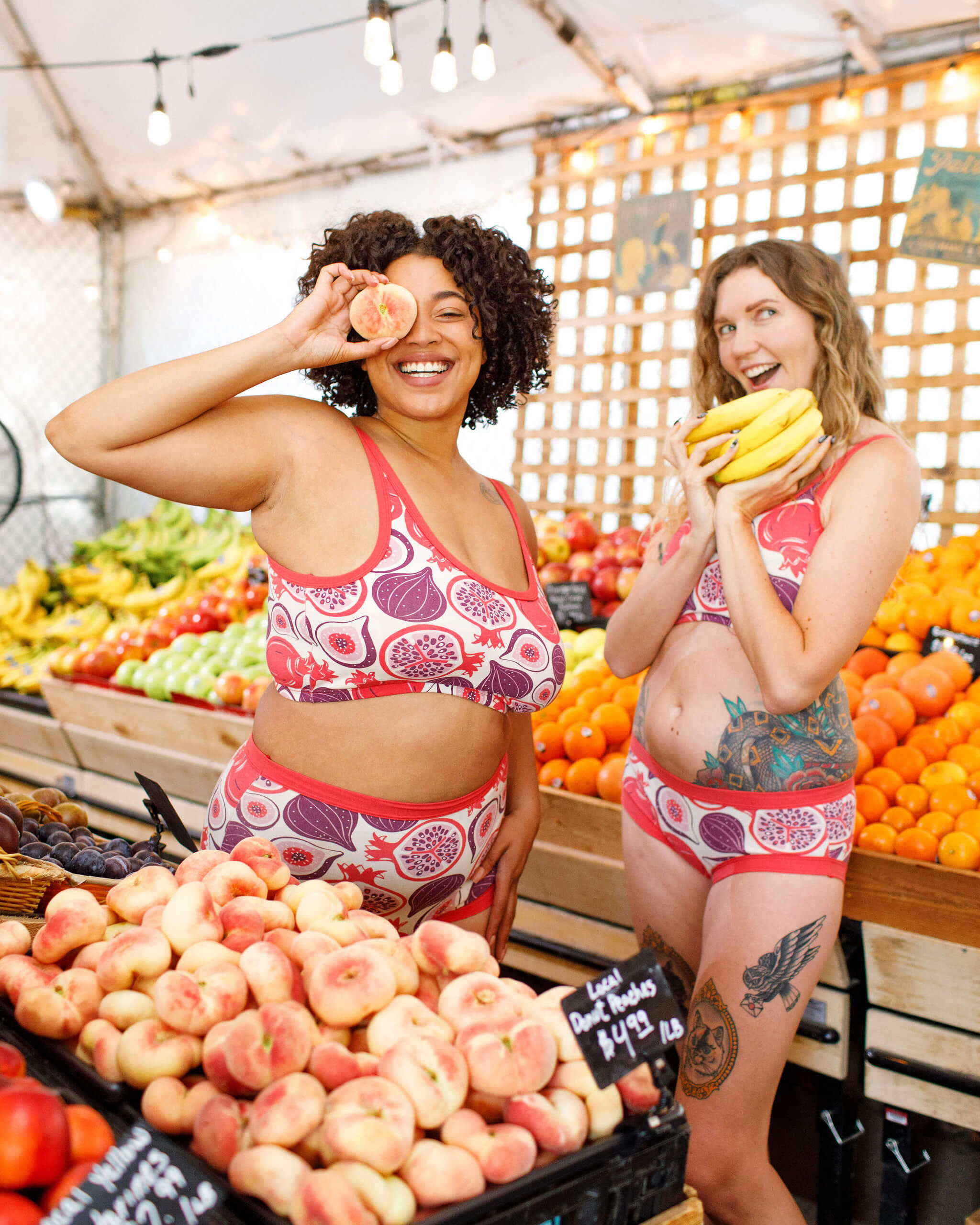 Two models wearing various Thunderpants items in Two Fruits - pomegranates and figs.