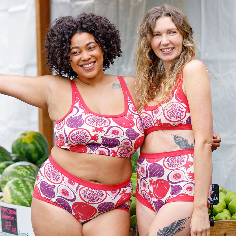 Two models wearing various Thunderpants items in Two Fruits - pomegranates and figs.