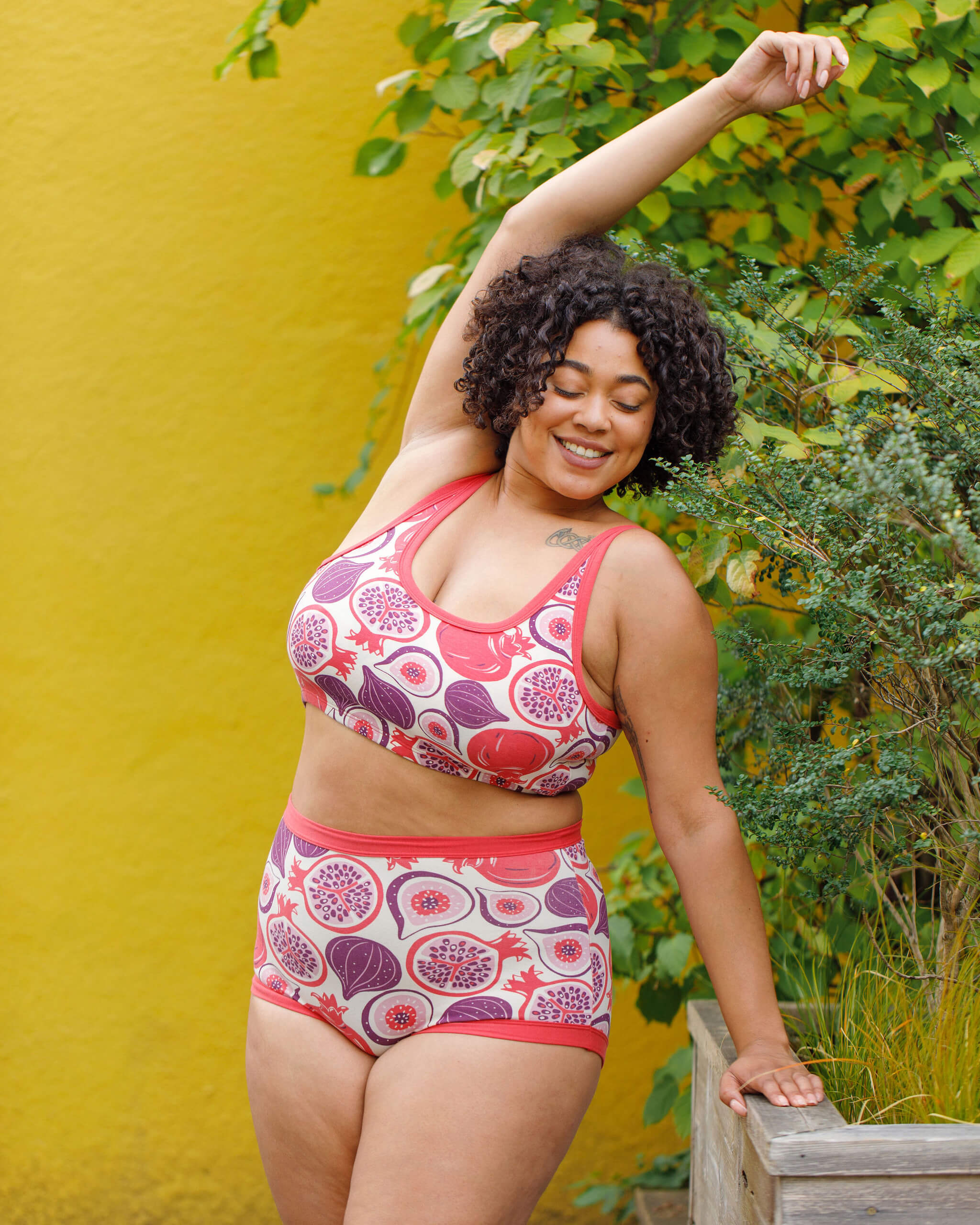 Model wearing Thunderpants Sky Rise style underwear and Longline Bra in Two Fruits - pomegranates and figs.