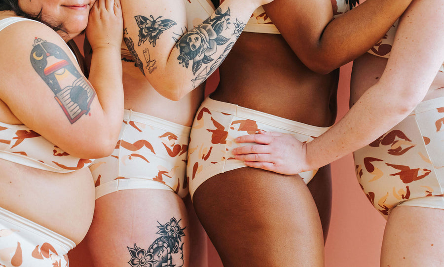 Close up of four models wearing various Thunderpants underwear styles in the Bodies in Motion print.