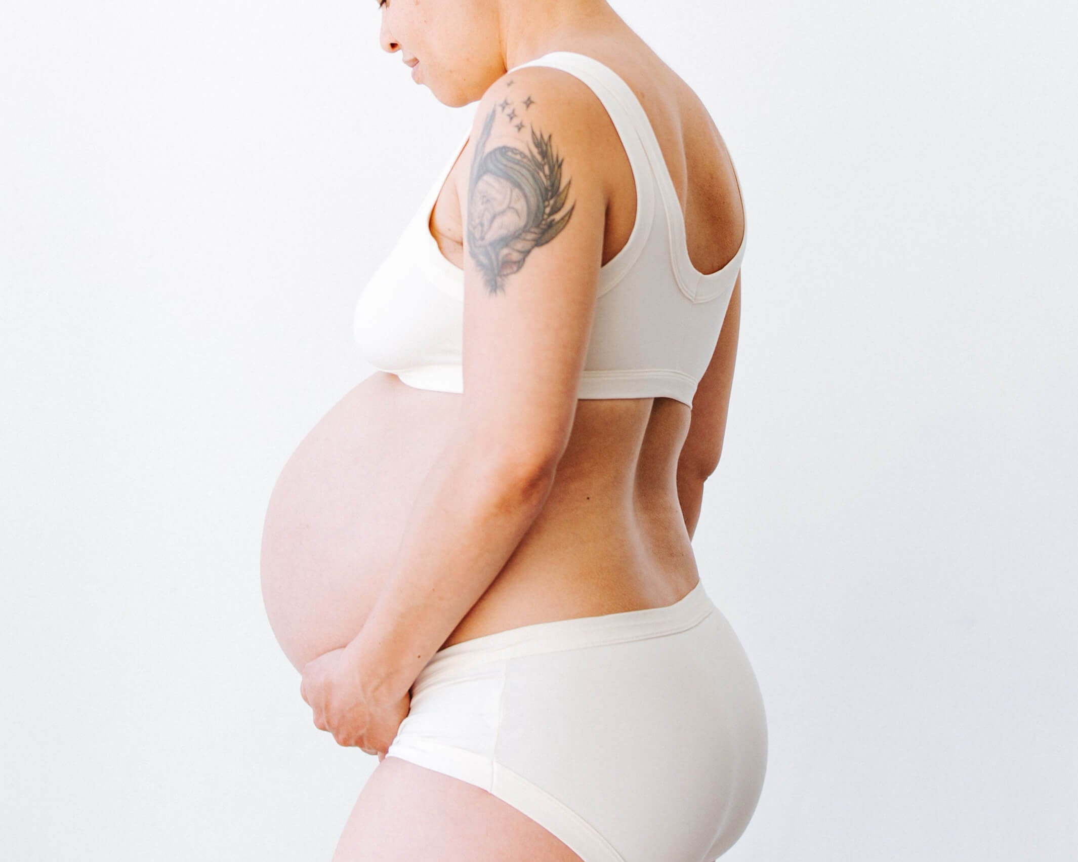 Pregnant model wearing Thunderpants Hipster style underwear and Bralette in Plain Vanilla.