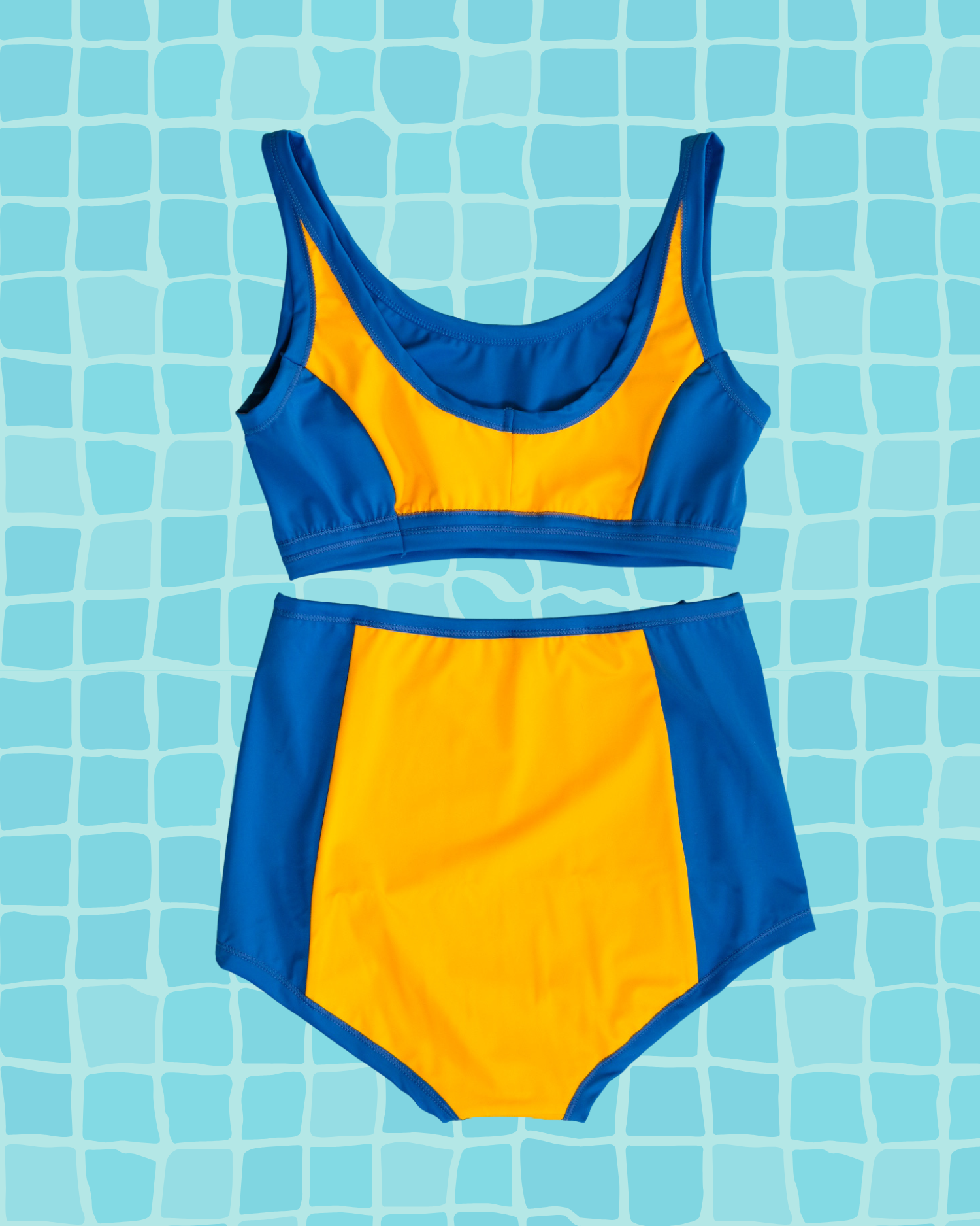 Flat lay of Thunderpants US yellow and blue paneled Swimwear Top and Sky Rise style bottoms. 