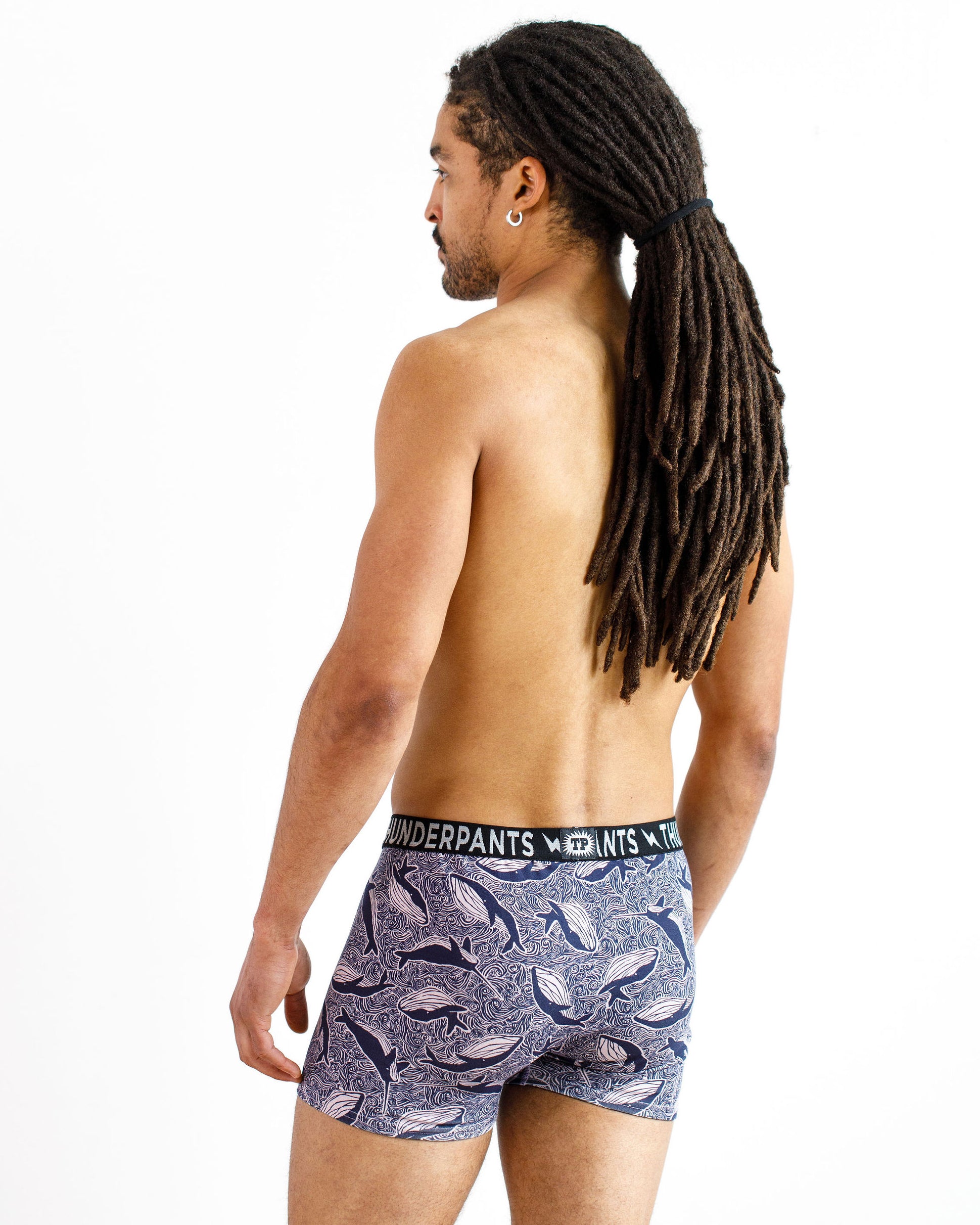 Male model wearing Thunderpants organic cotton Boxer Brief style underwear in a blue Whale print.