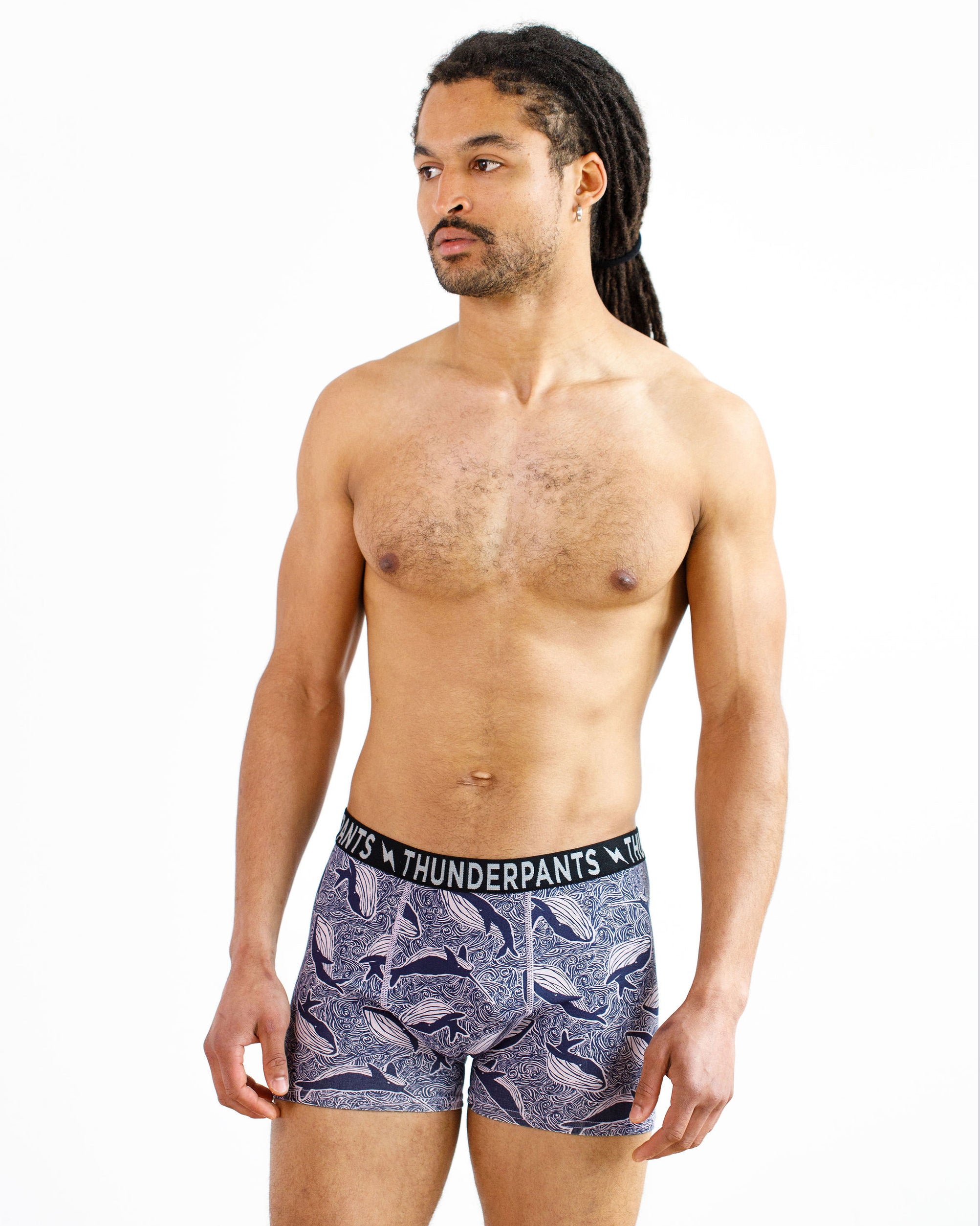 Male model wearing Thunderpants organic cotton Boxer Brief style underwear in a blue Whale print.