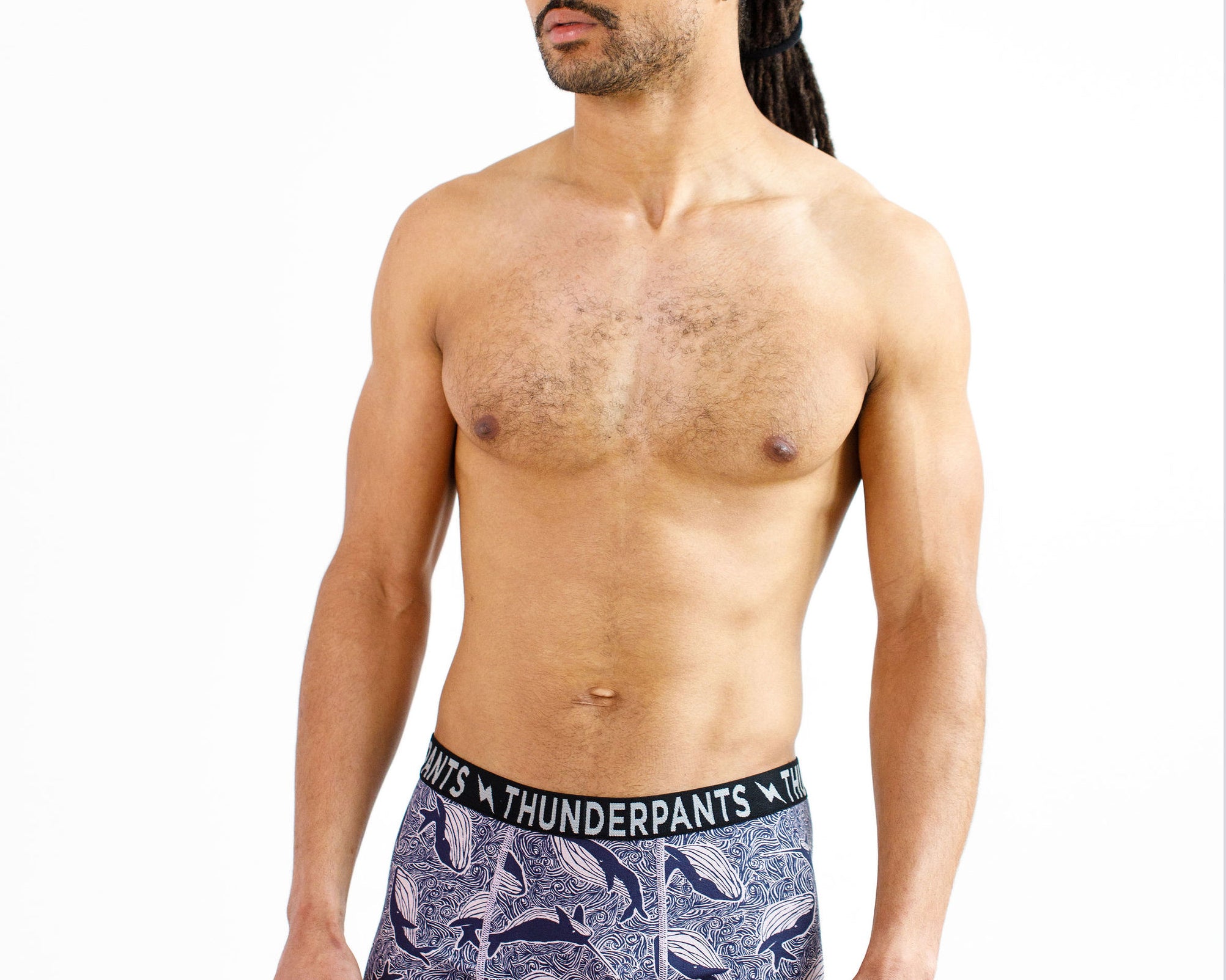 Male model wearing Thunderpants organic cotton Boxer Brief style underwear in a blue Whale print.