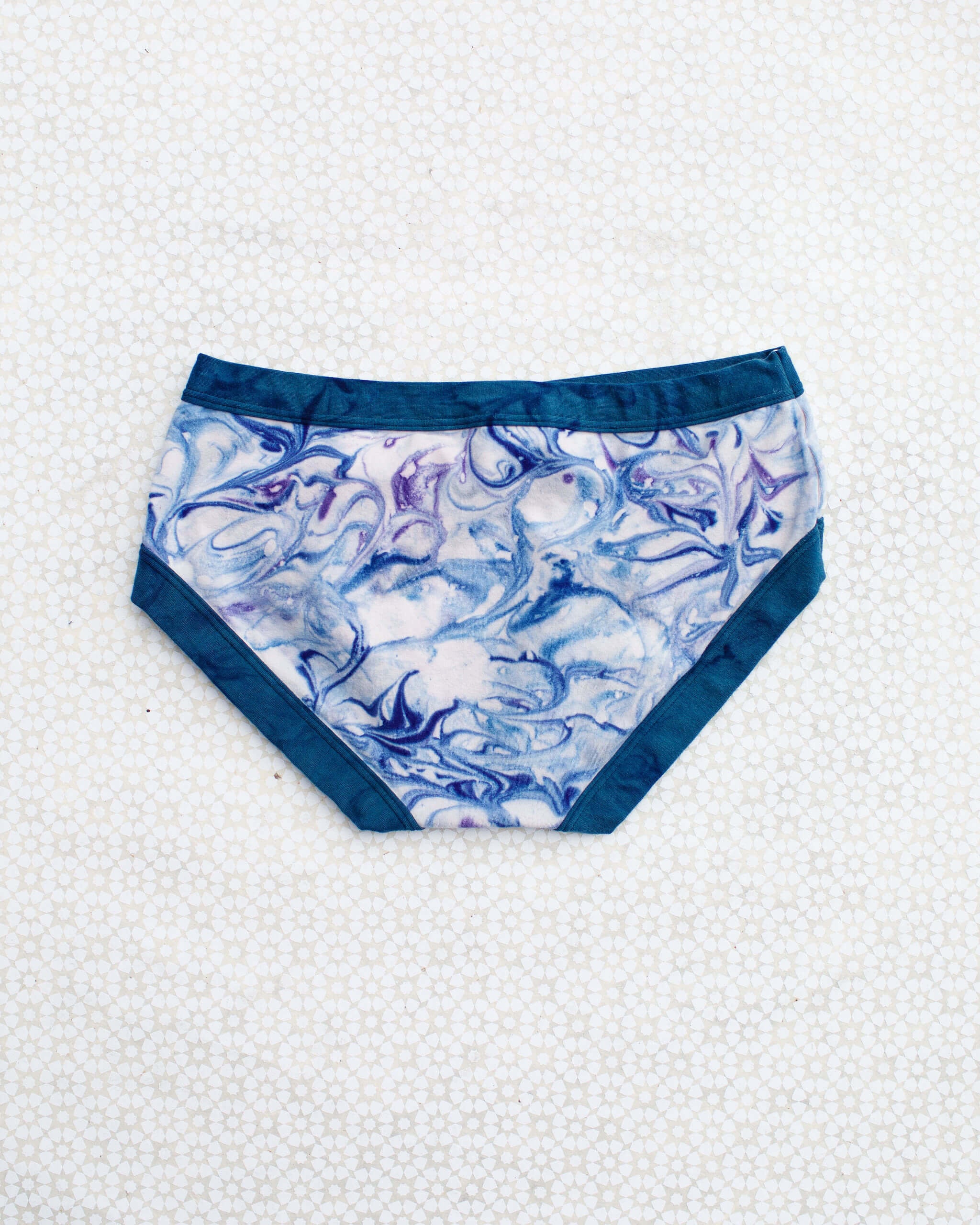 Flat lay of Thunderpants Hipster style underwear in Winter Blues Marble dye - different blues and purples swirled to look like marble. 