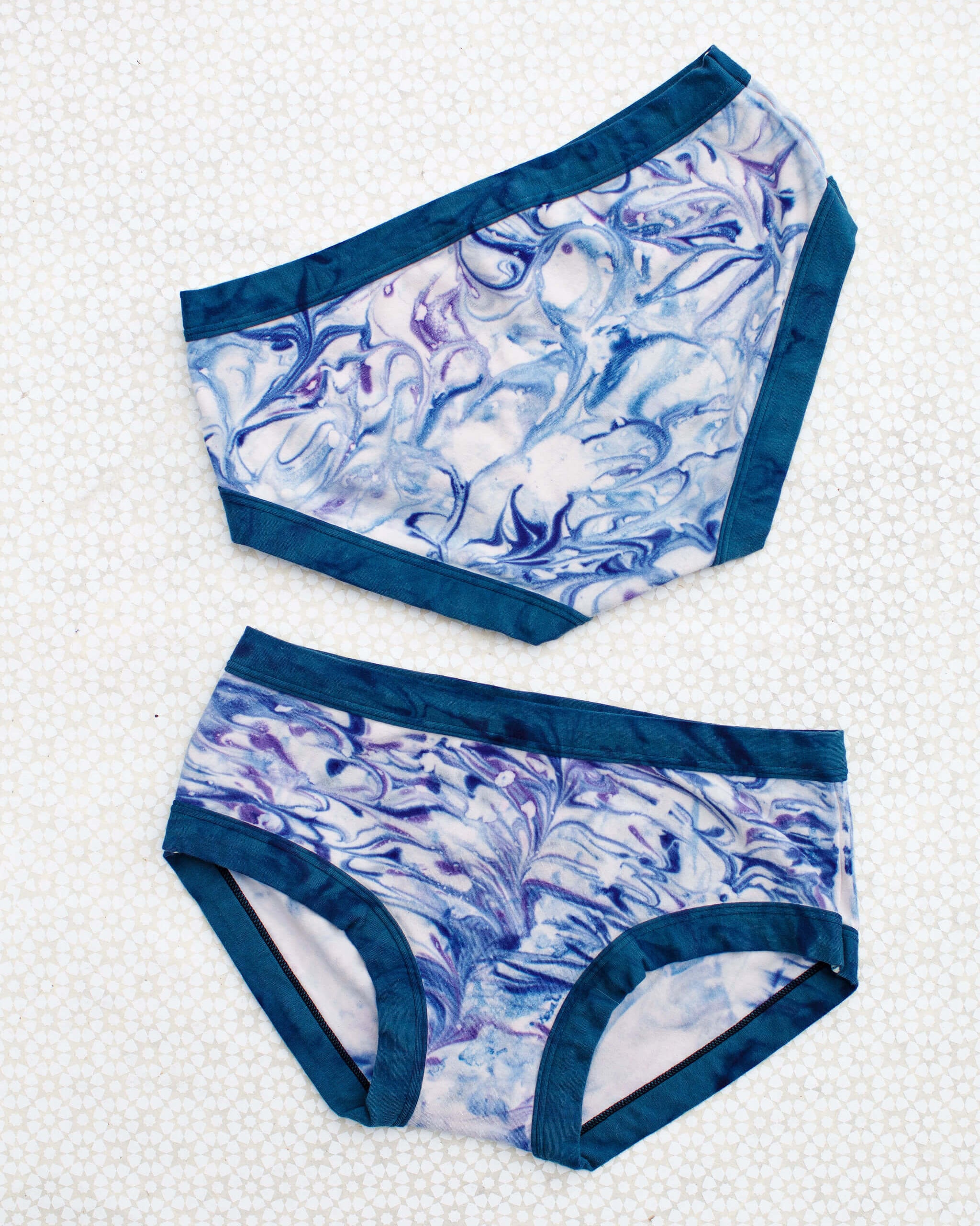 Flat lay of Thunderpants Hipster style underwear in Winter Blues Marble dye - different blues and purples swirled to look like marble. 