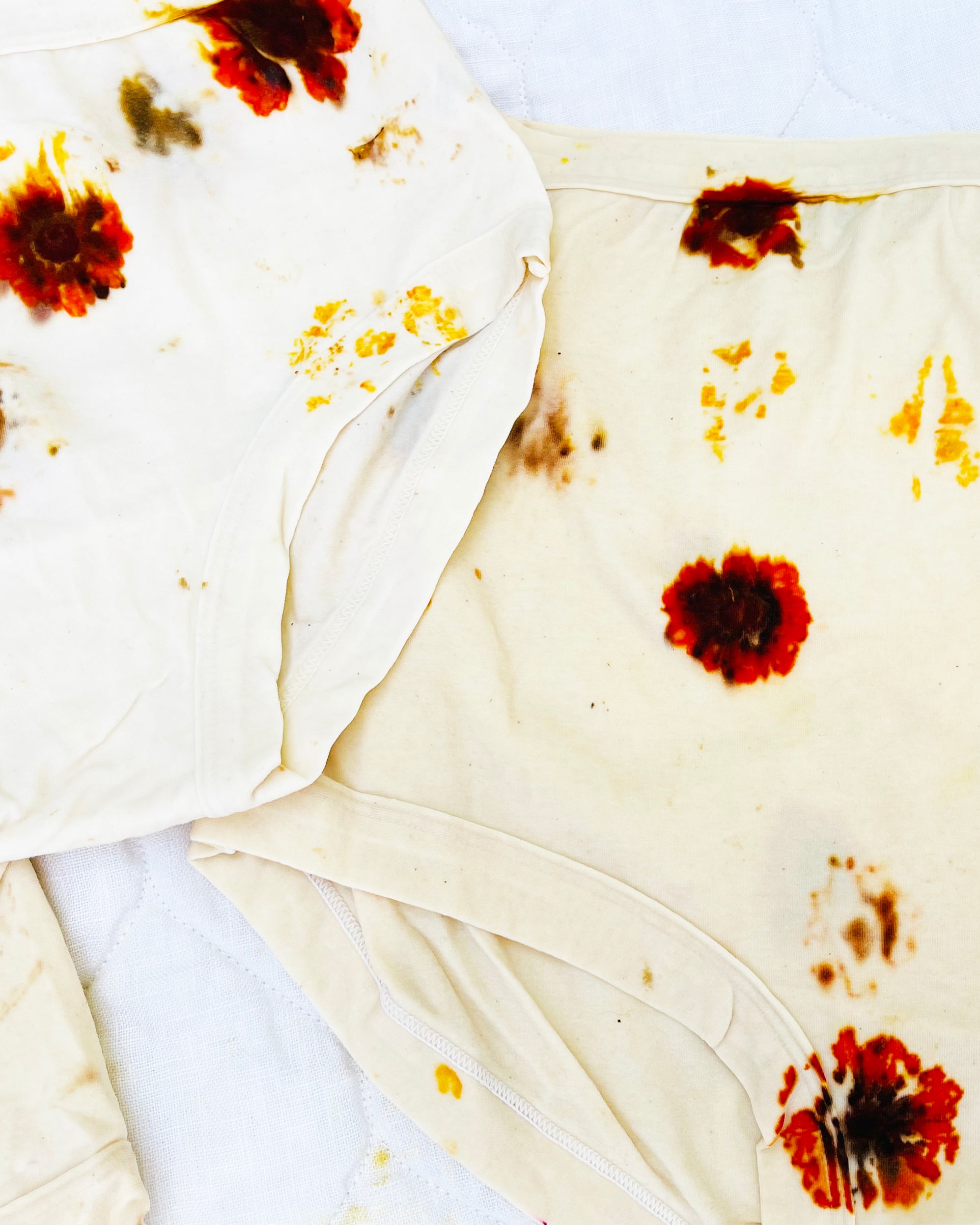 Close up photo of the dying process with wet flower prints on underwear.