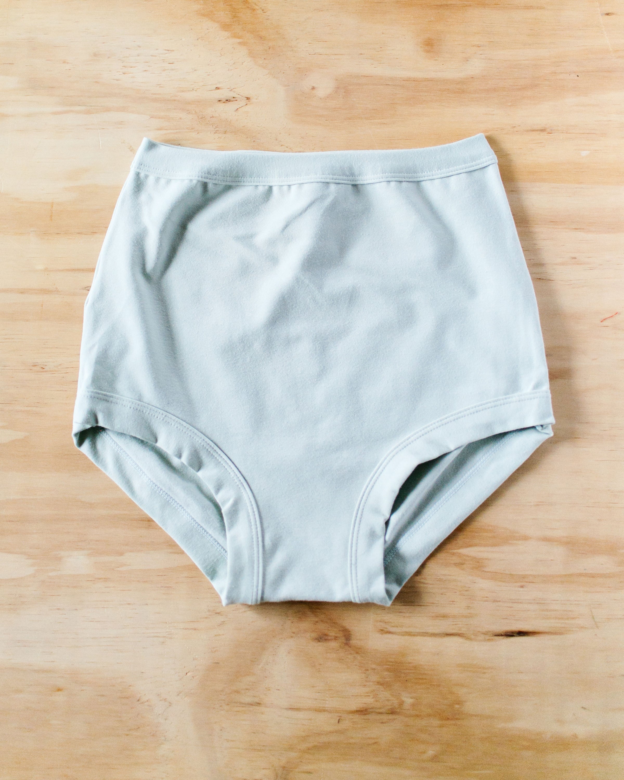 Flat lay of Thunderpants organic cotton Sky Rise style underwear in Dried Sage color.
