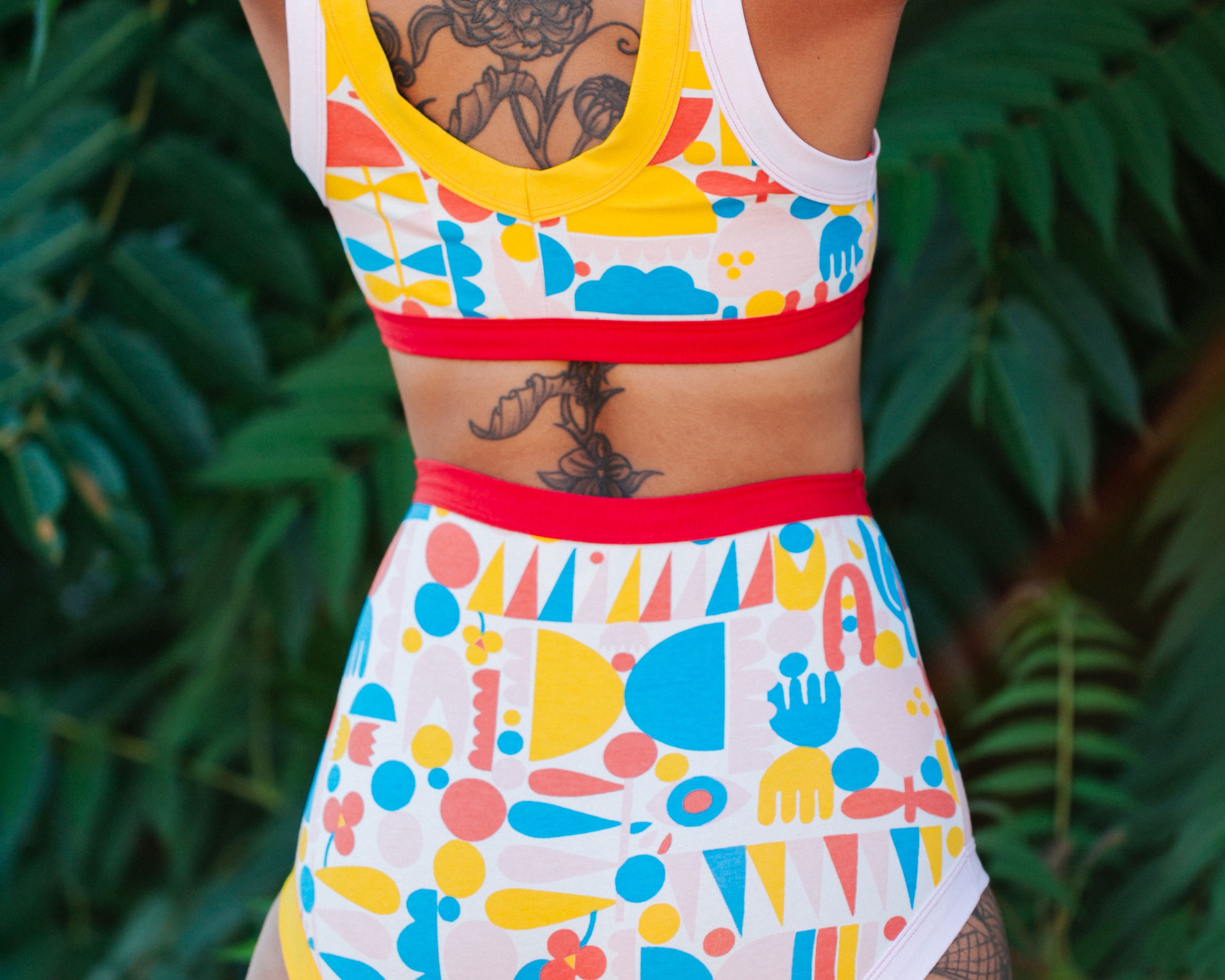 Close up of the bum of a model wearing Sky Rise style underwear and Bralette in Balance by Lisa Congdon print: geometric shapes in pink, red, blue, and yellow colors.