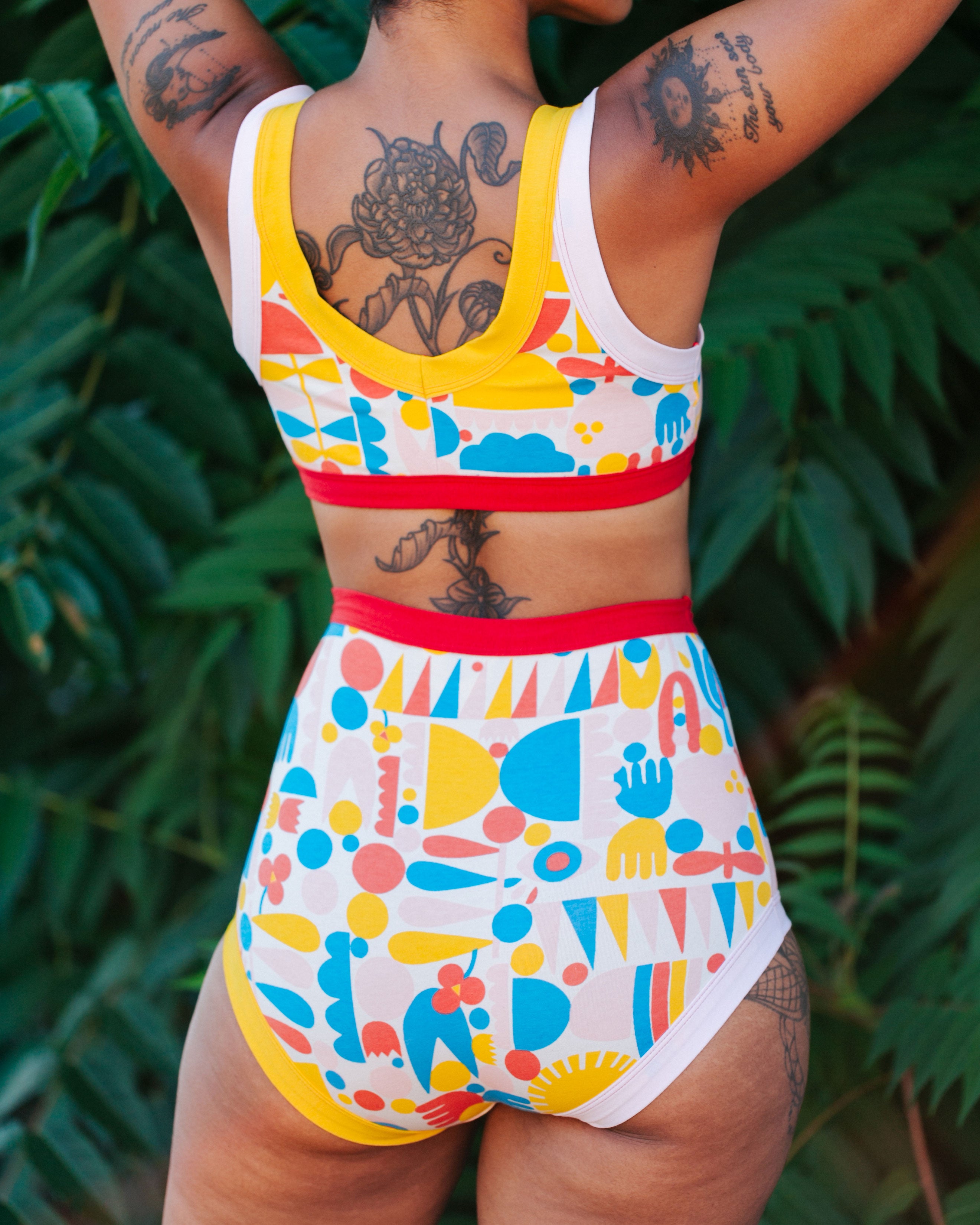Close up of the bum of a model wearing Sky Rise style underwear and Bralette in Balance by Lisa Congdon print: geometric shapes in pink, red, blue, and yellow colors.