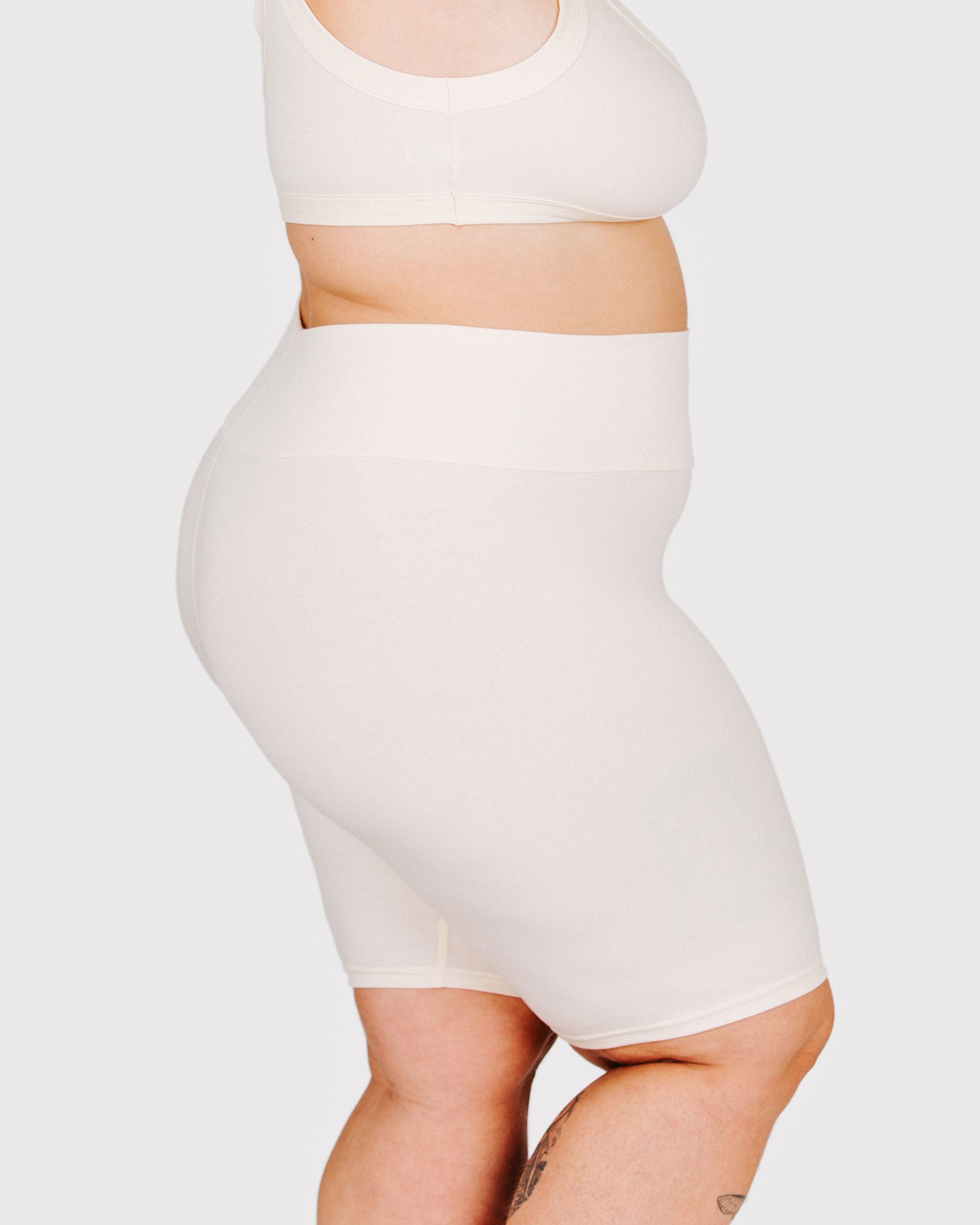 Fit photo from the side of Thunderpants organic cotton Bike Shorts in off-white on a model.