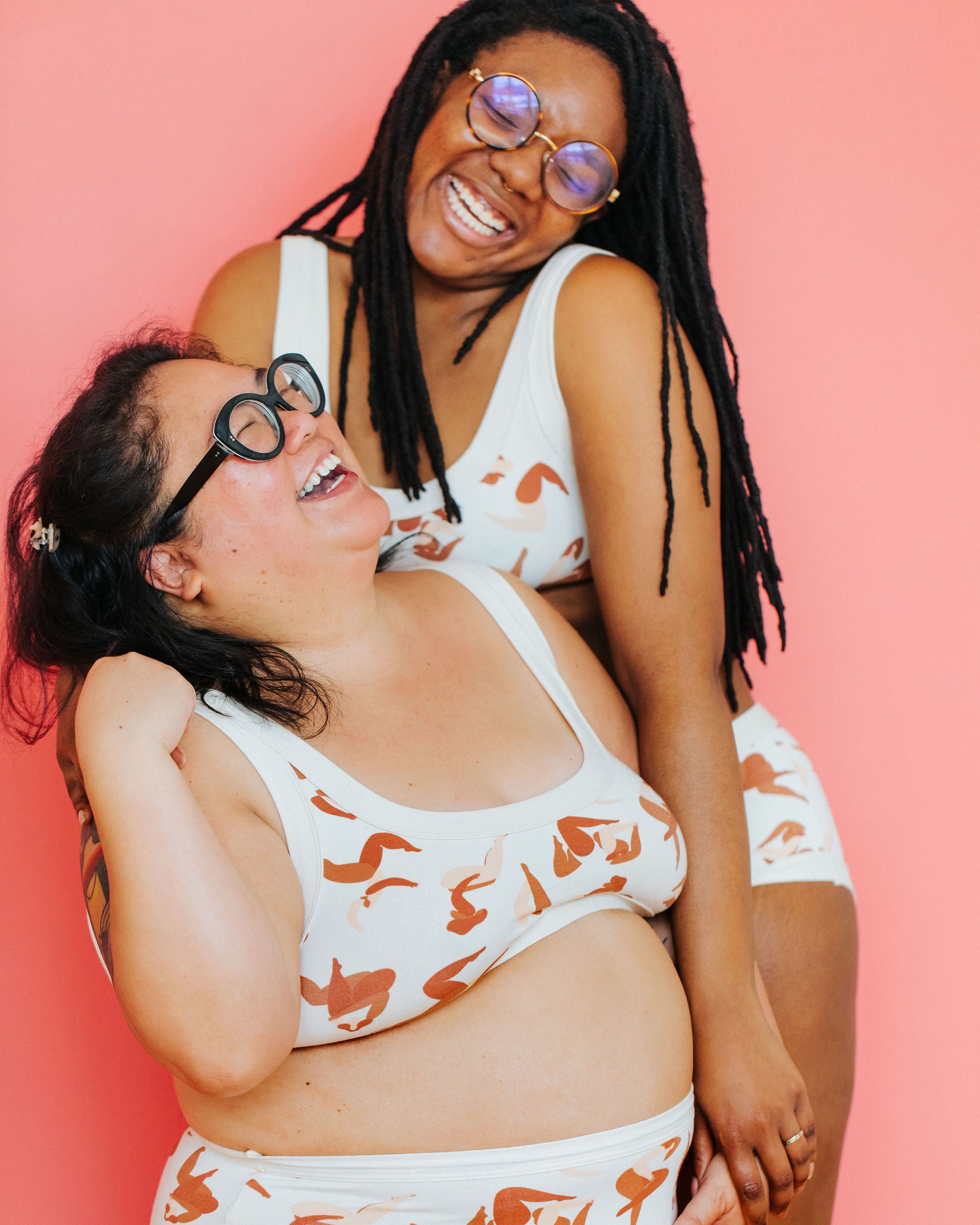 Models laughing together wearing Thunderpants Bralette in Bodies in Motion: women in different shades of tans and browns.
