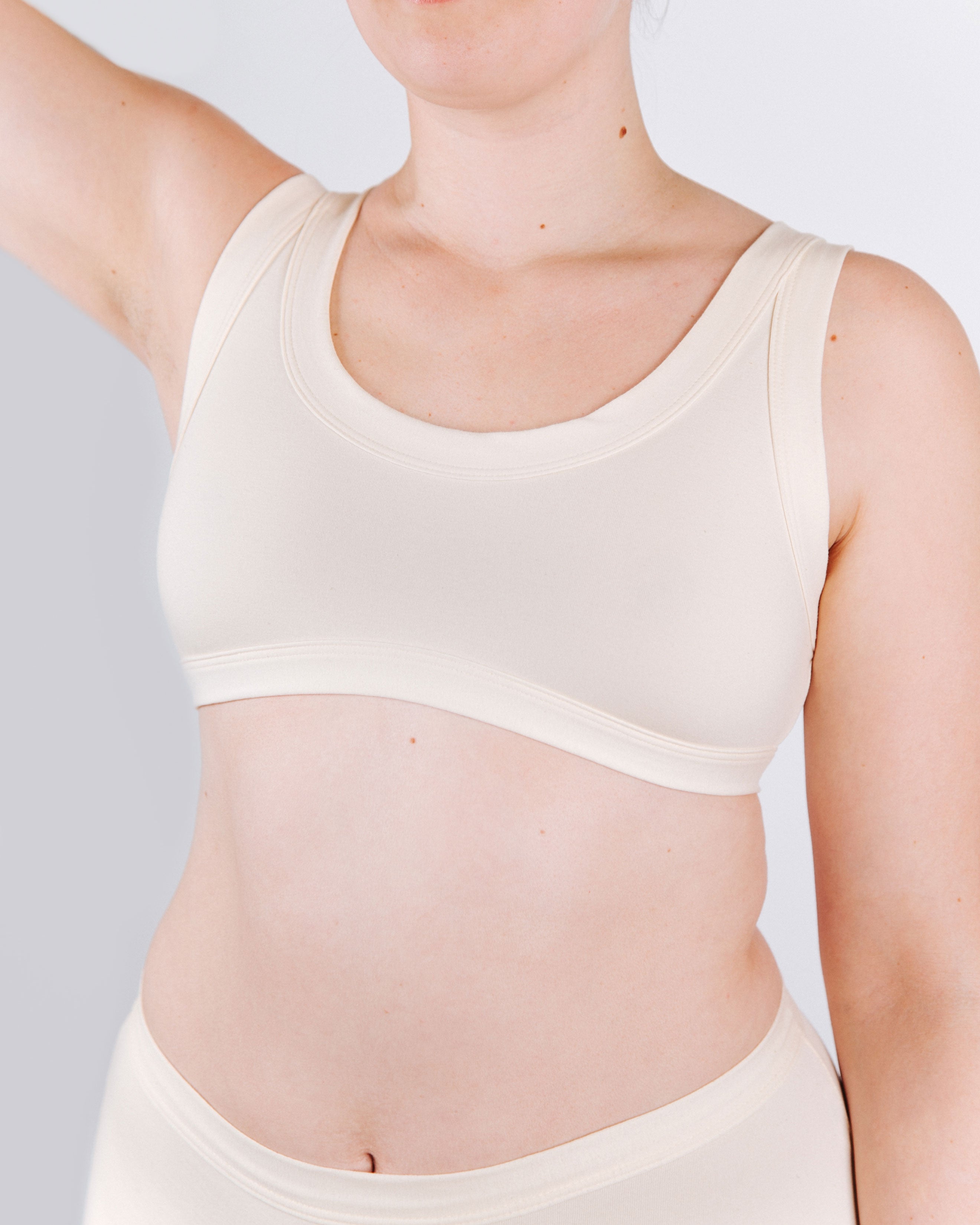 Close-up fit photo from the front of Thunderpants organic cotton Bralette in off-white on a model.