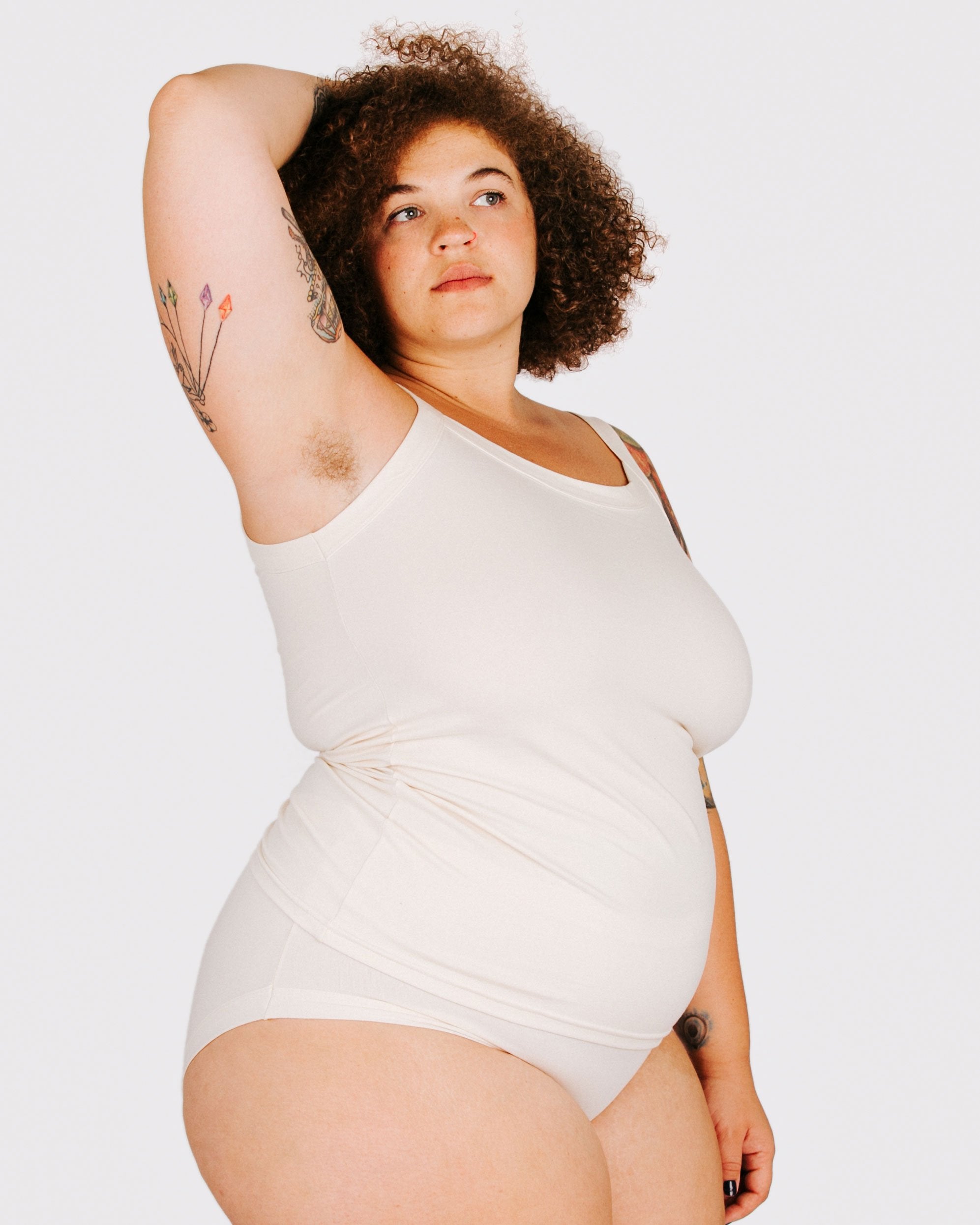 Fit photo from the side of Thunderpants organic cotton Camisole and Hipster style underwear in off-white on a model.