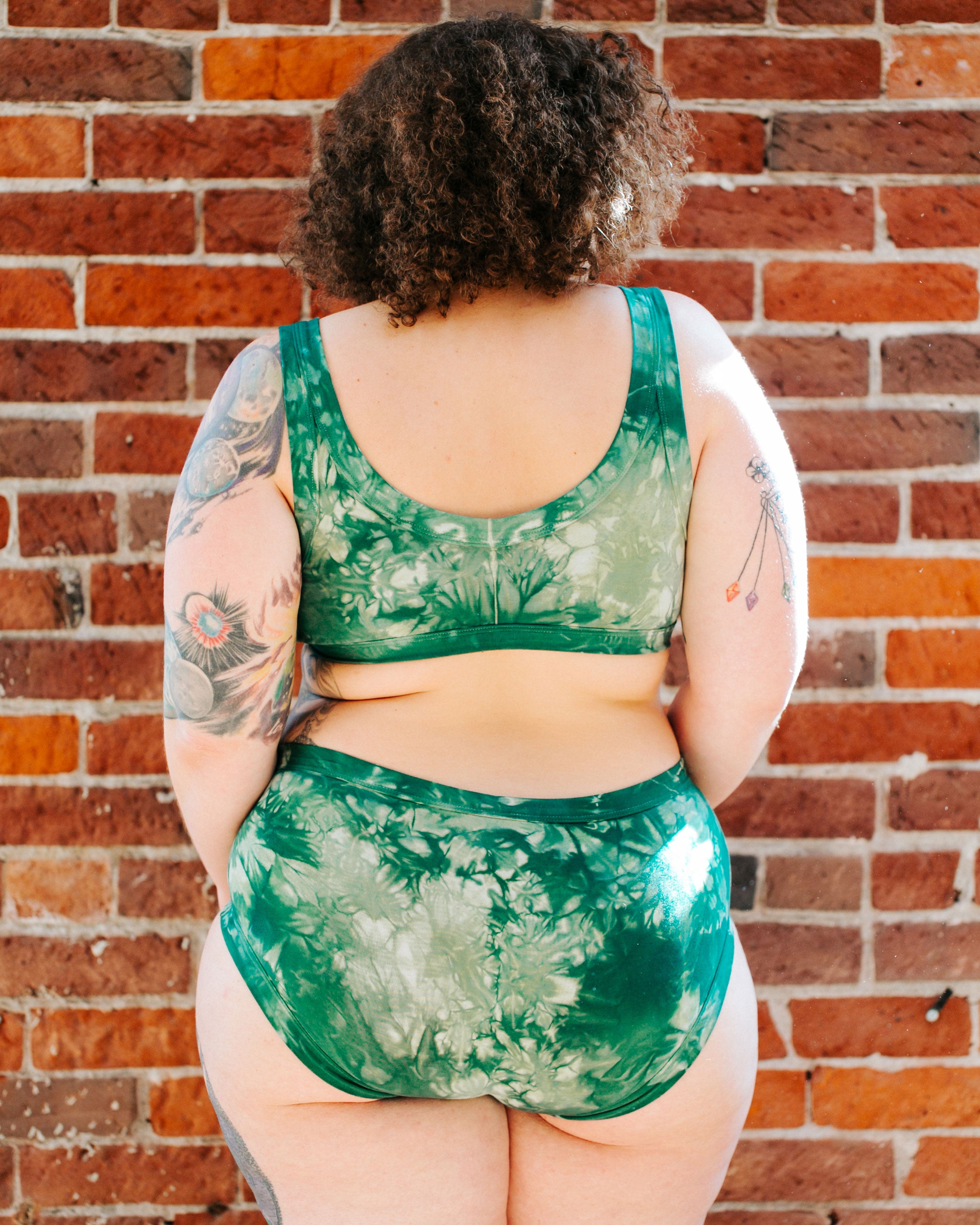 Back of model wearing Thunderpants organic cotton Hipster style underwear and Bralette in Clover Green scrunch dye.