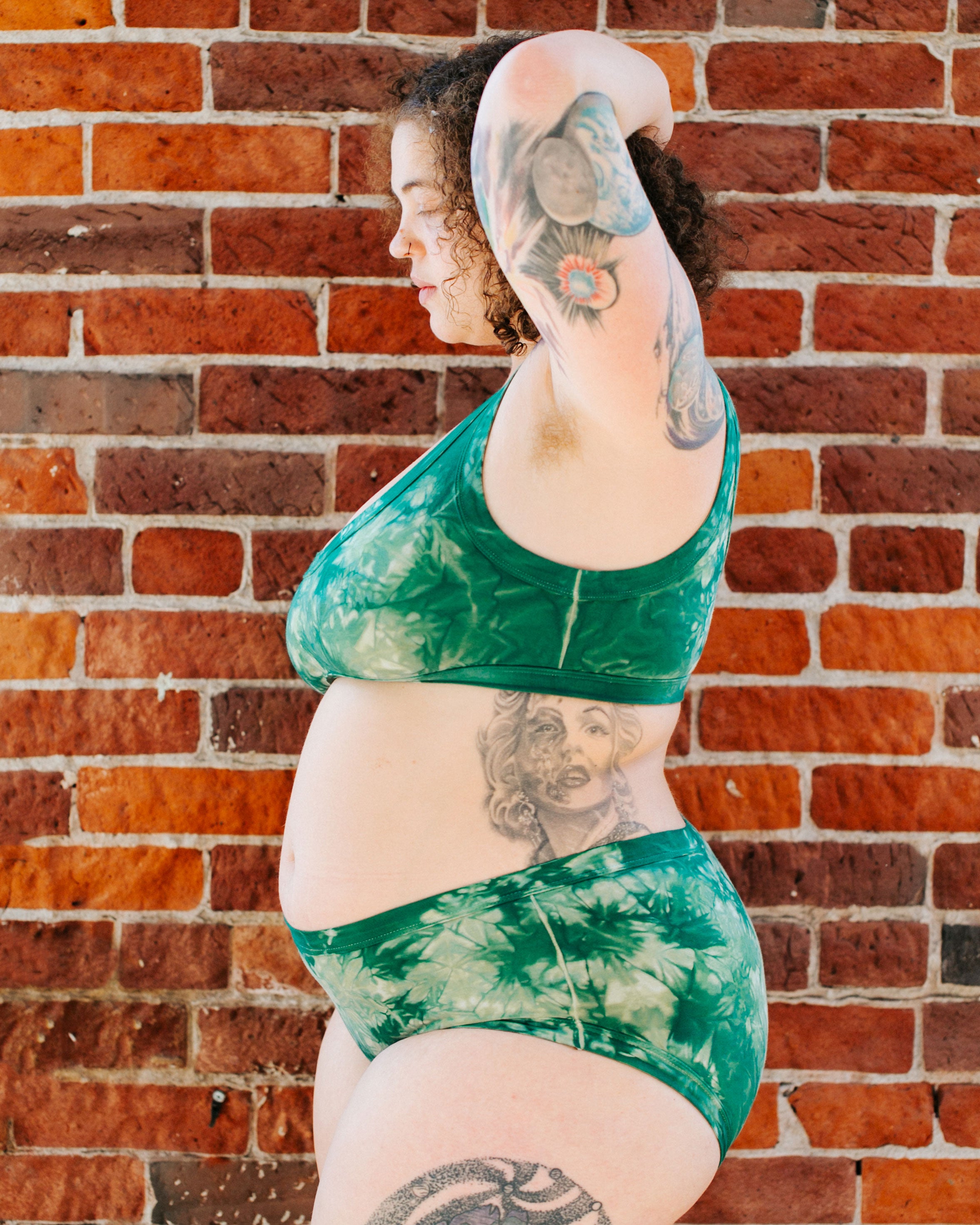 Side of model wearing Thunderpants organic cotton Hipster style underwear and Bralette in Clover Green scrunch dye.