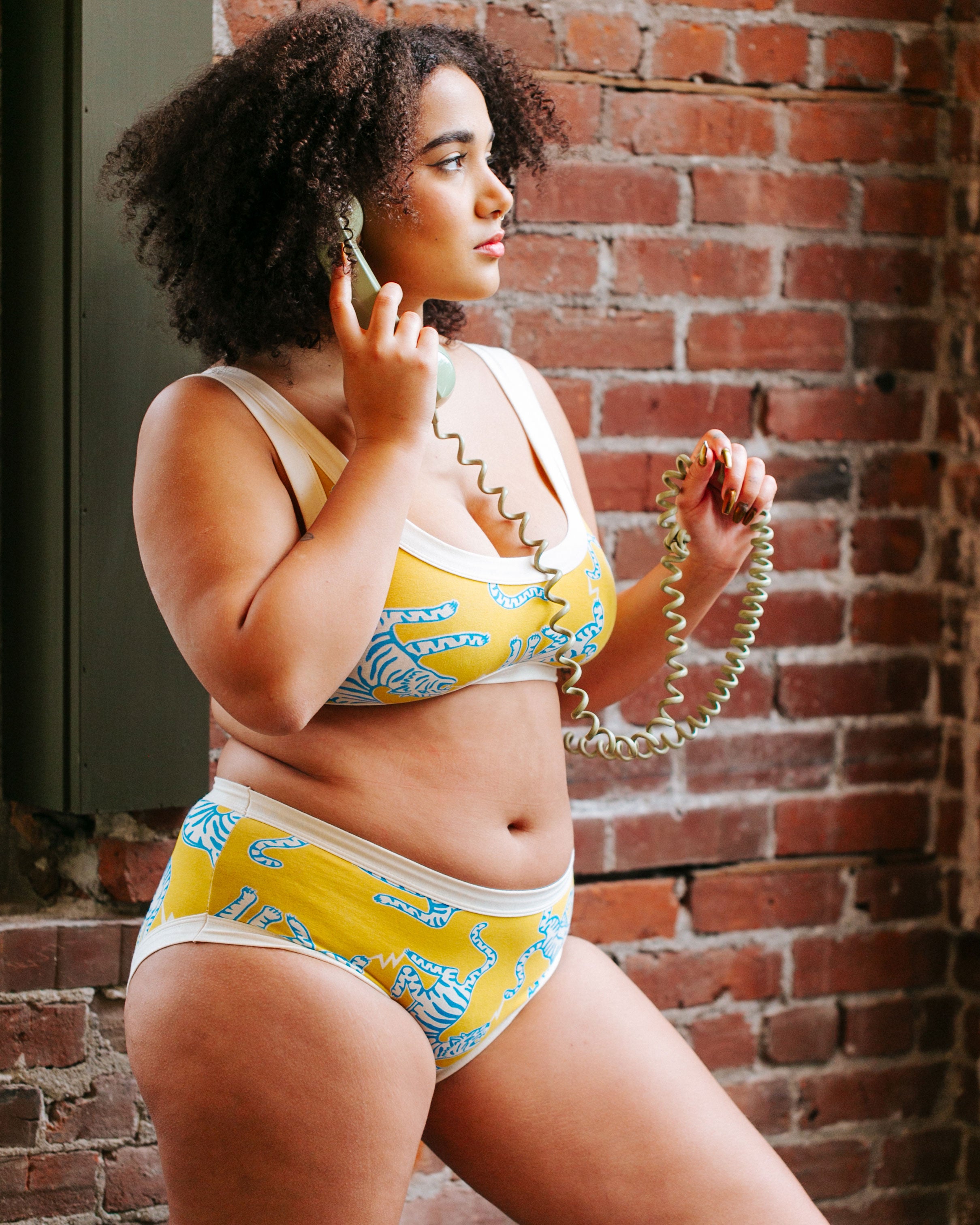 Model wearing Thunderpants organic cotton Hipster style underwear and Bralette in Easy Tiger - chartreuse with blue and white tigers.
