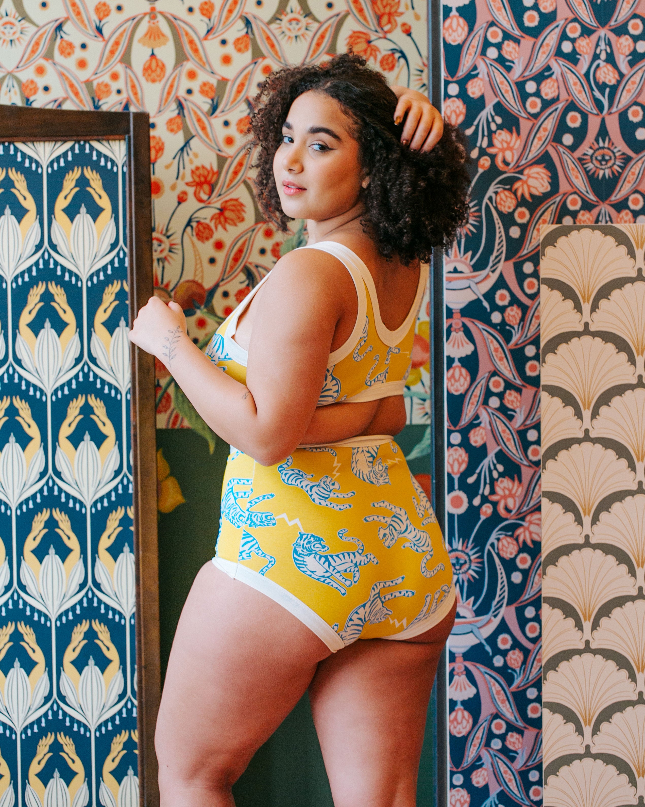 Back of model wearing Thunderpants organic cotton Sky Rise style underwear and Bralette in Easy Tiger - chartreuse with blue and white tigers.