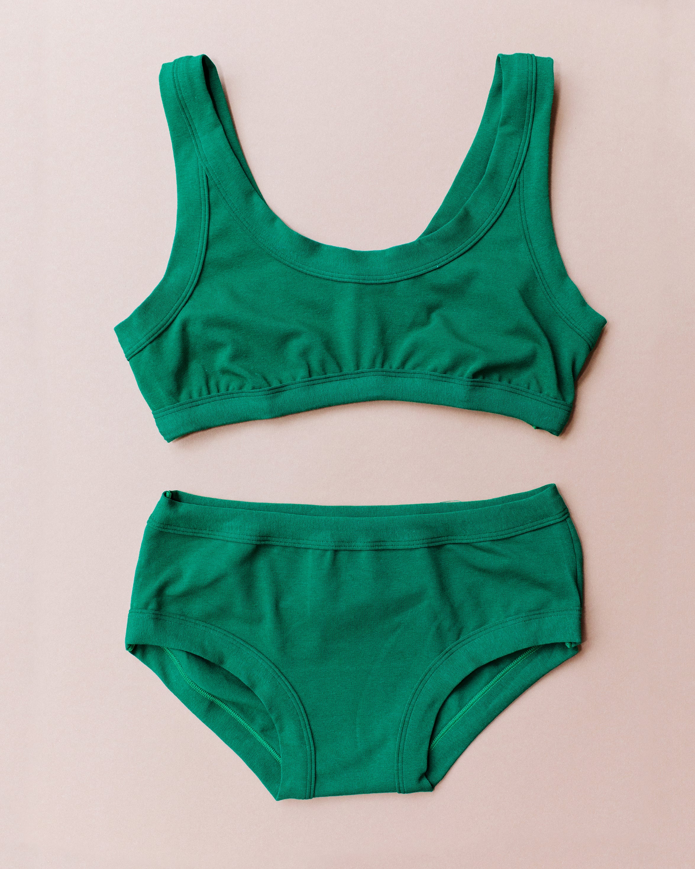 Flat lay of Thunderpants Hipster style underwear and Bralette set in Emerald Green.