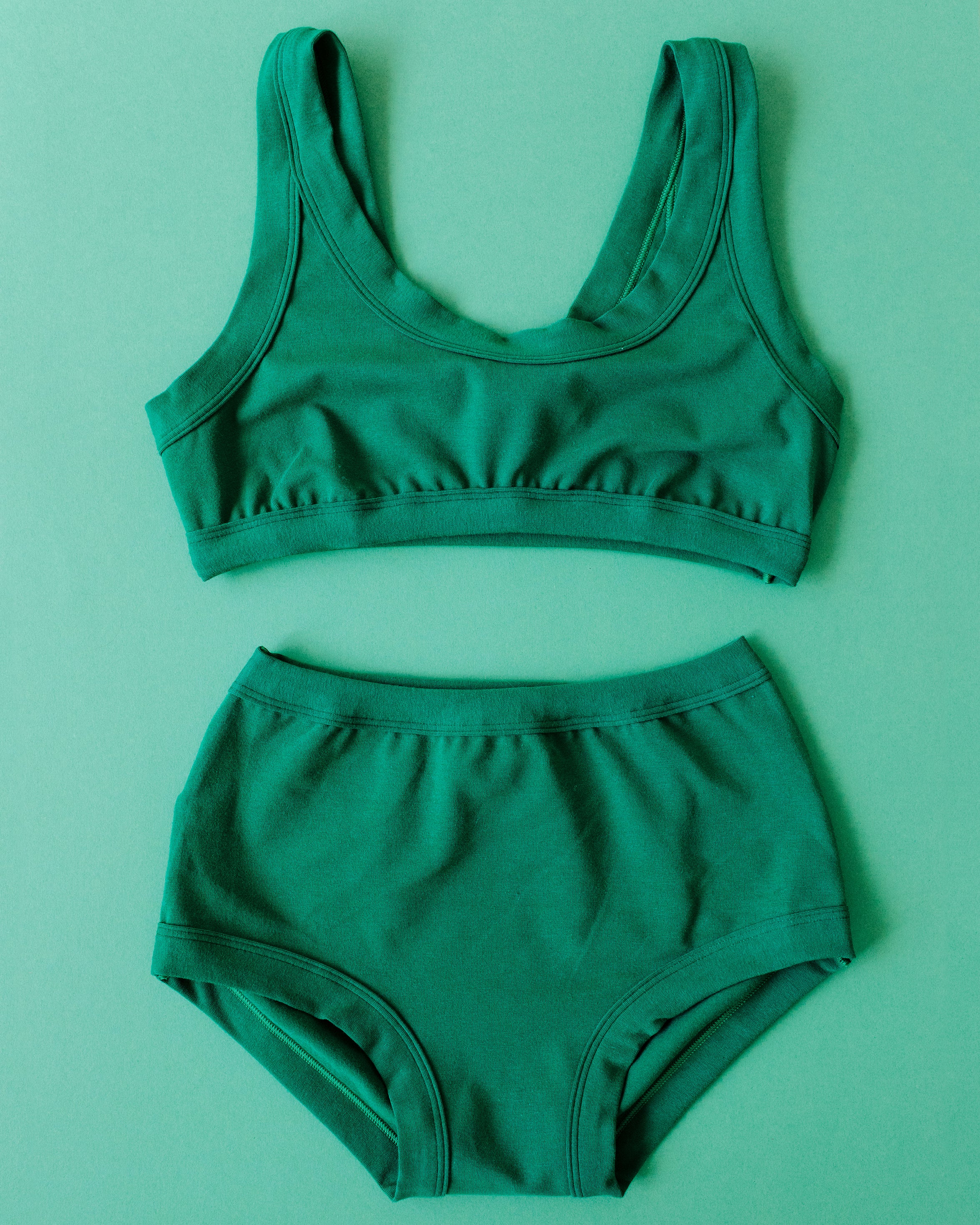 Flat lay of Thunderpants Bralette and Original style underwear set in Emerald Green.