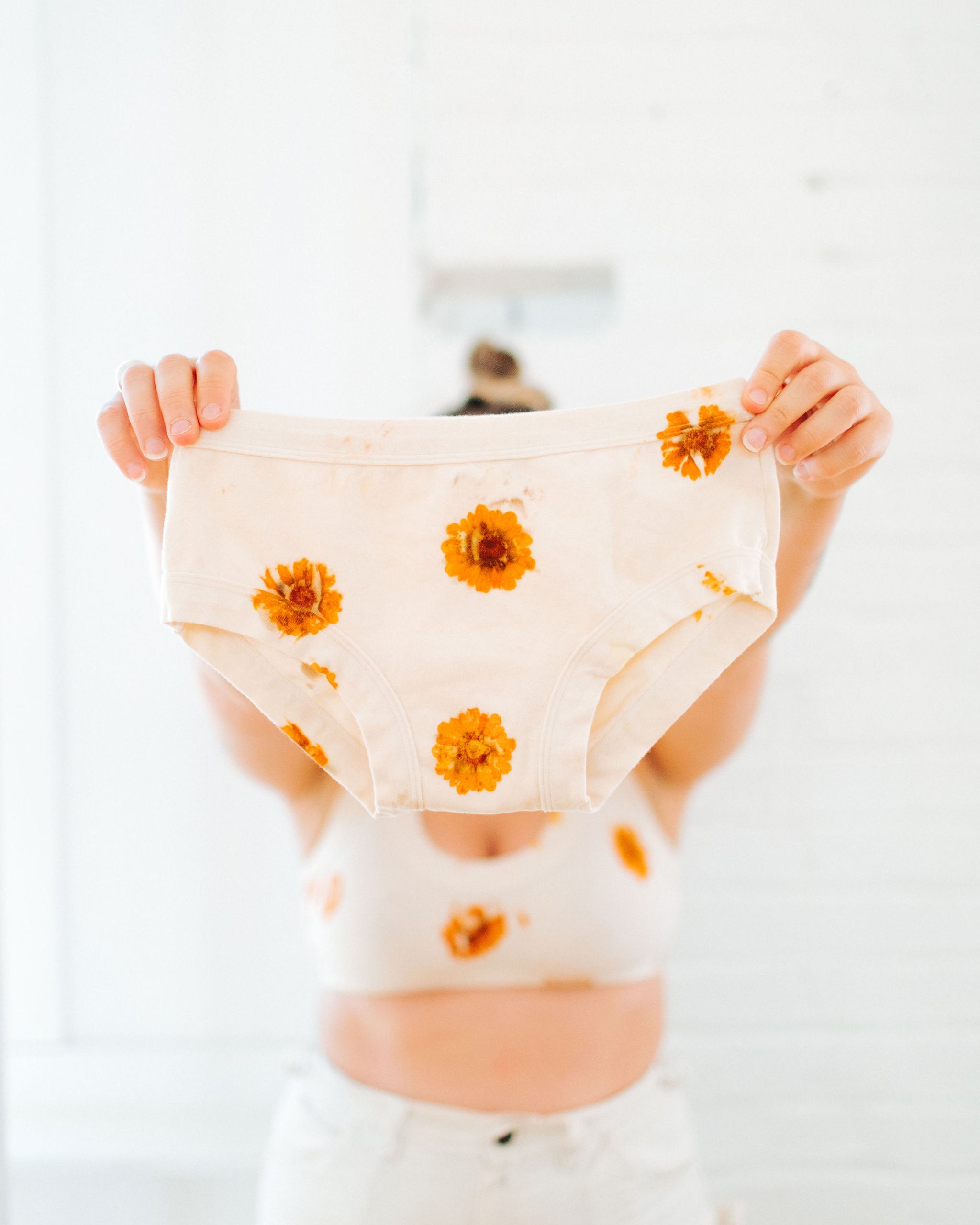 Person holding Thunderpants Hipster style underwear in the Limited Edition Flower Press Botanical Dye - flowers pressed onto the fabric to create a print.