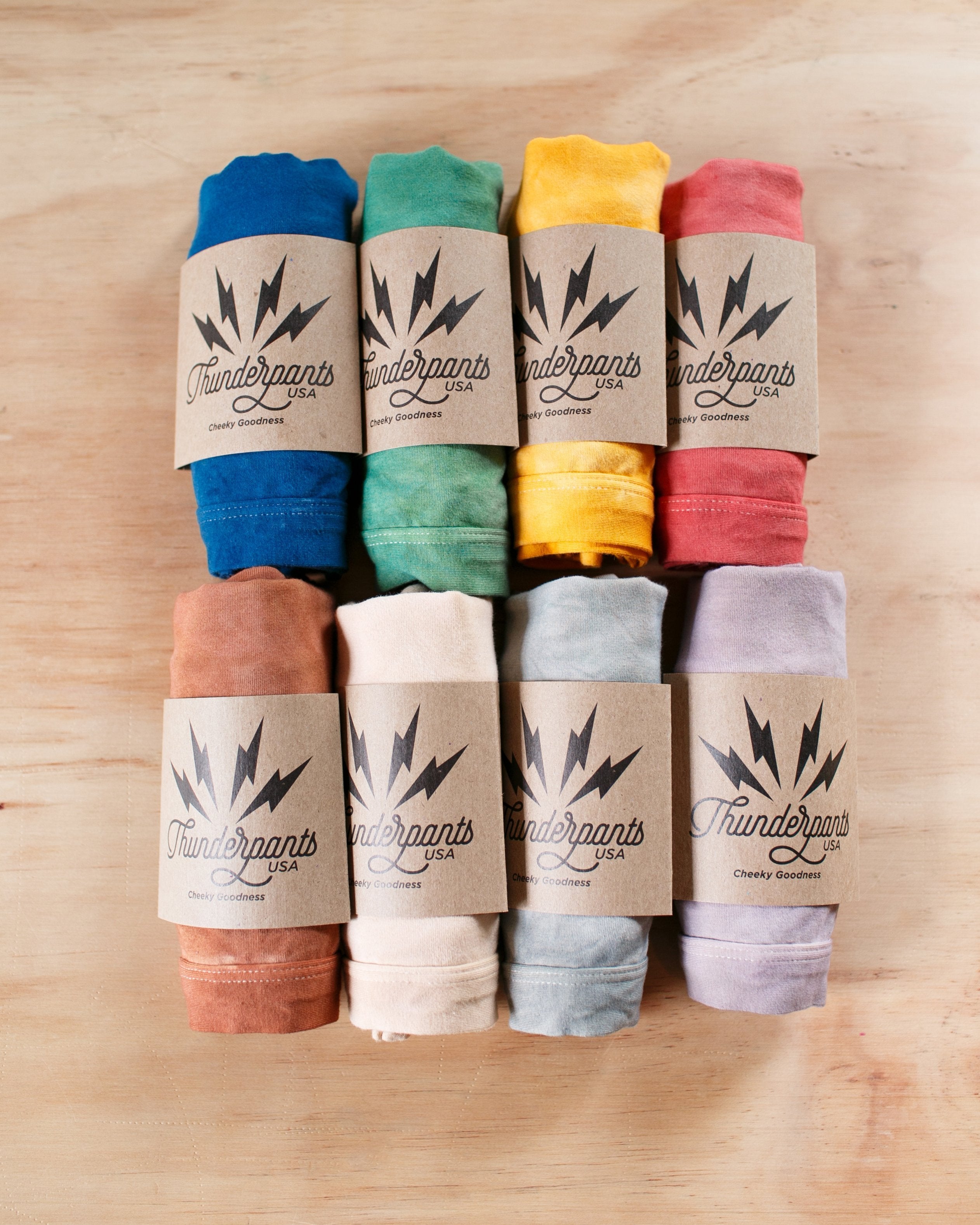 Eight colors of organic cotton limited edition hand dyed underwear in their Thunderpants packaging.