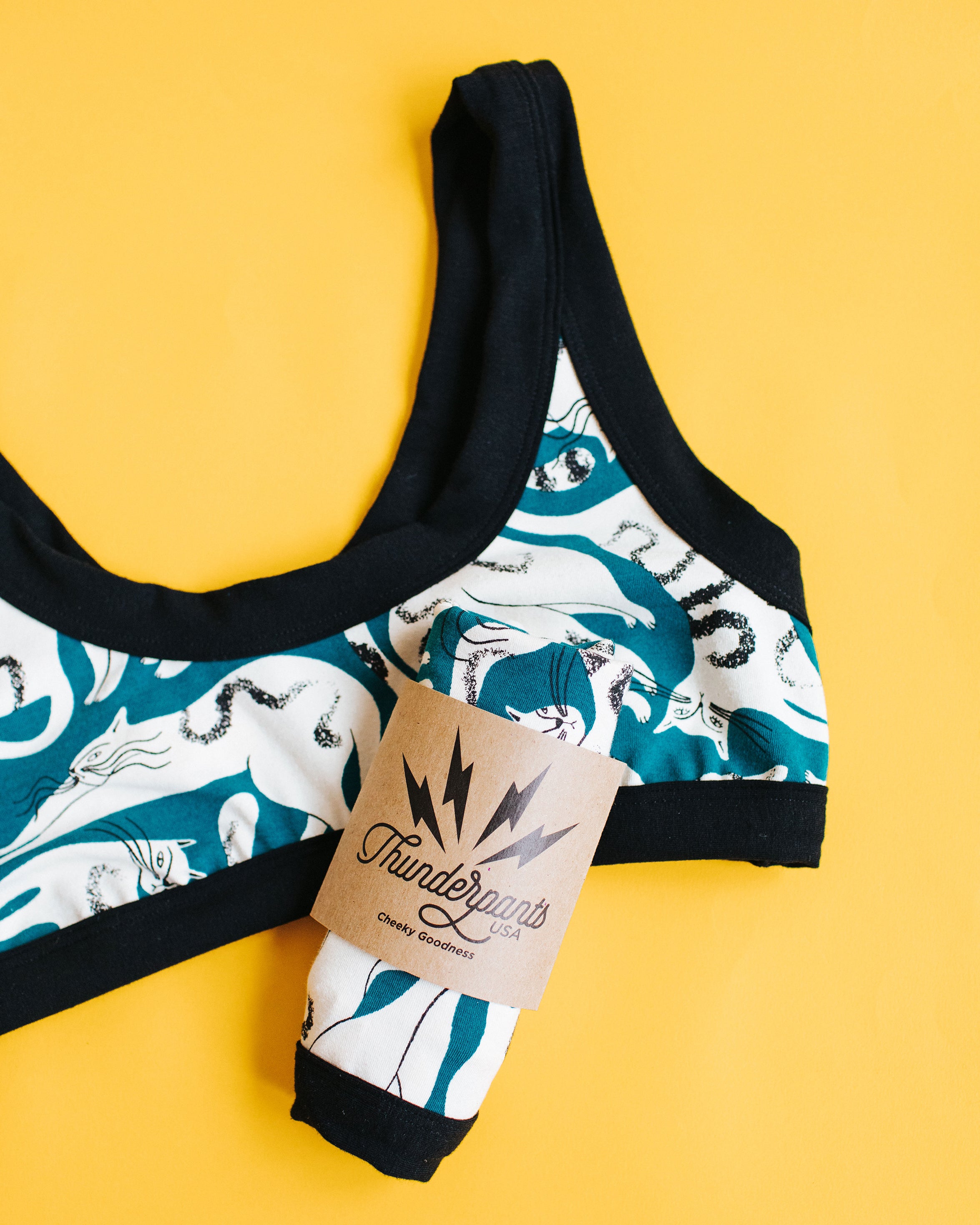 Flat lay of Thunderpants Bralette in Hey Meow! print - green with white cats
